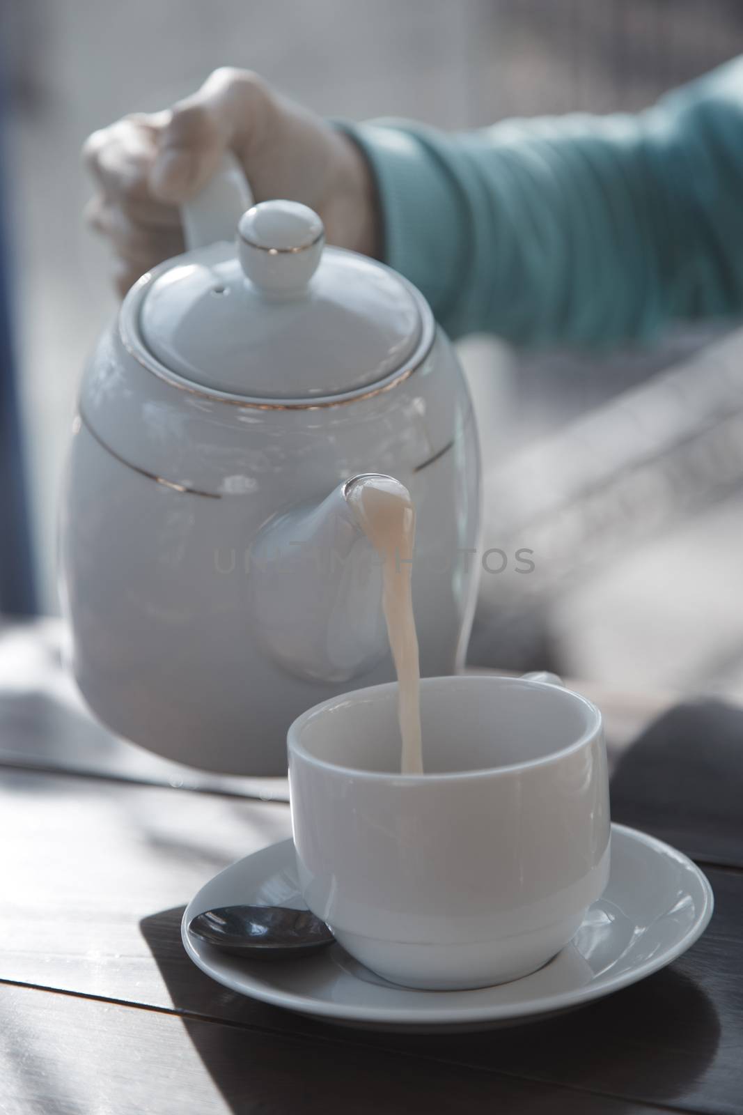 Woman pouring tea from teapot