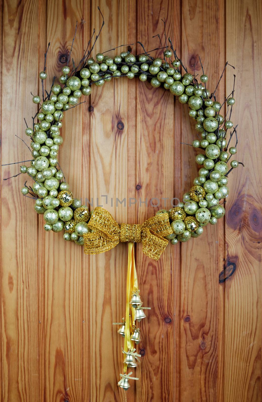 The wedding wreath hangs on a wooden wall by alarich