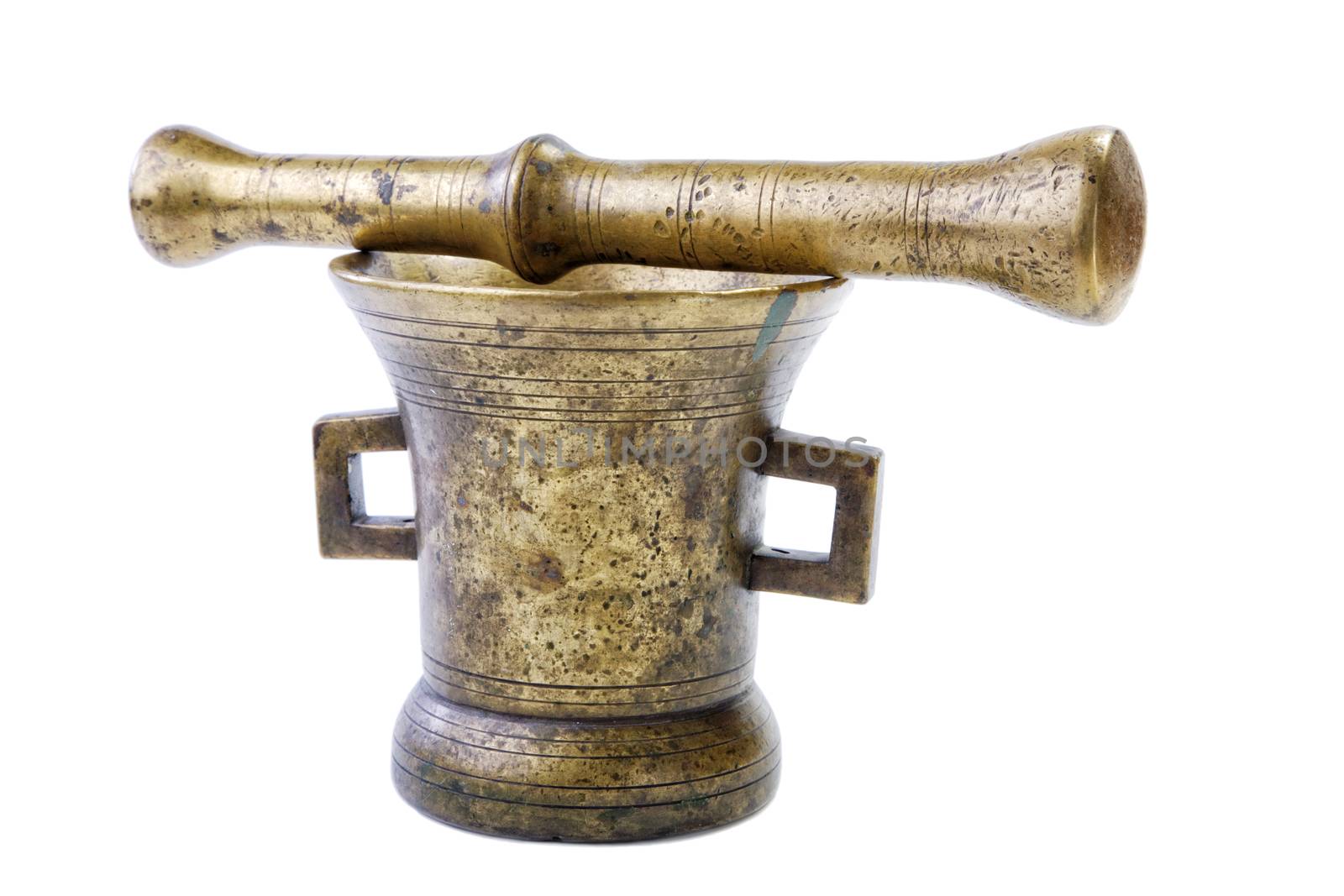 Brass mortar with a pestle isolated on a white background