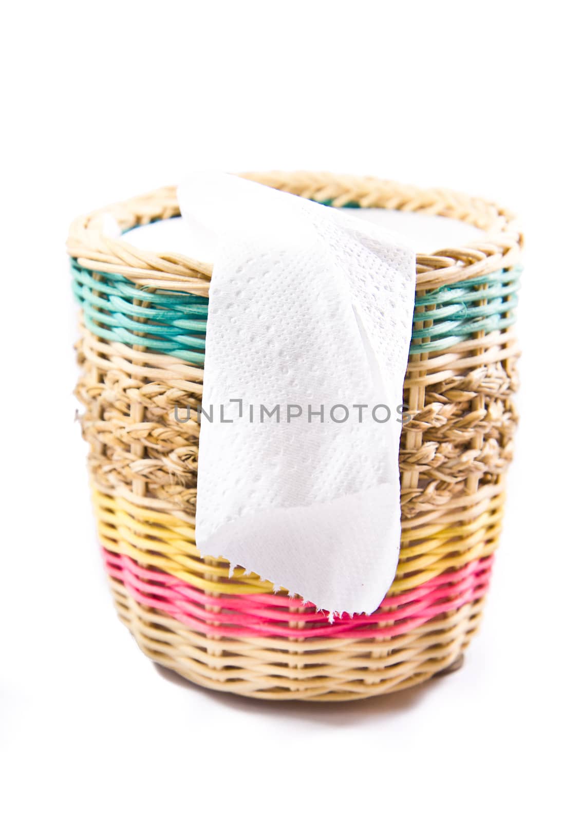 close up of white toilet paper in colorful box on white backgrou by tisskananat