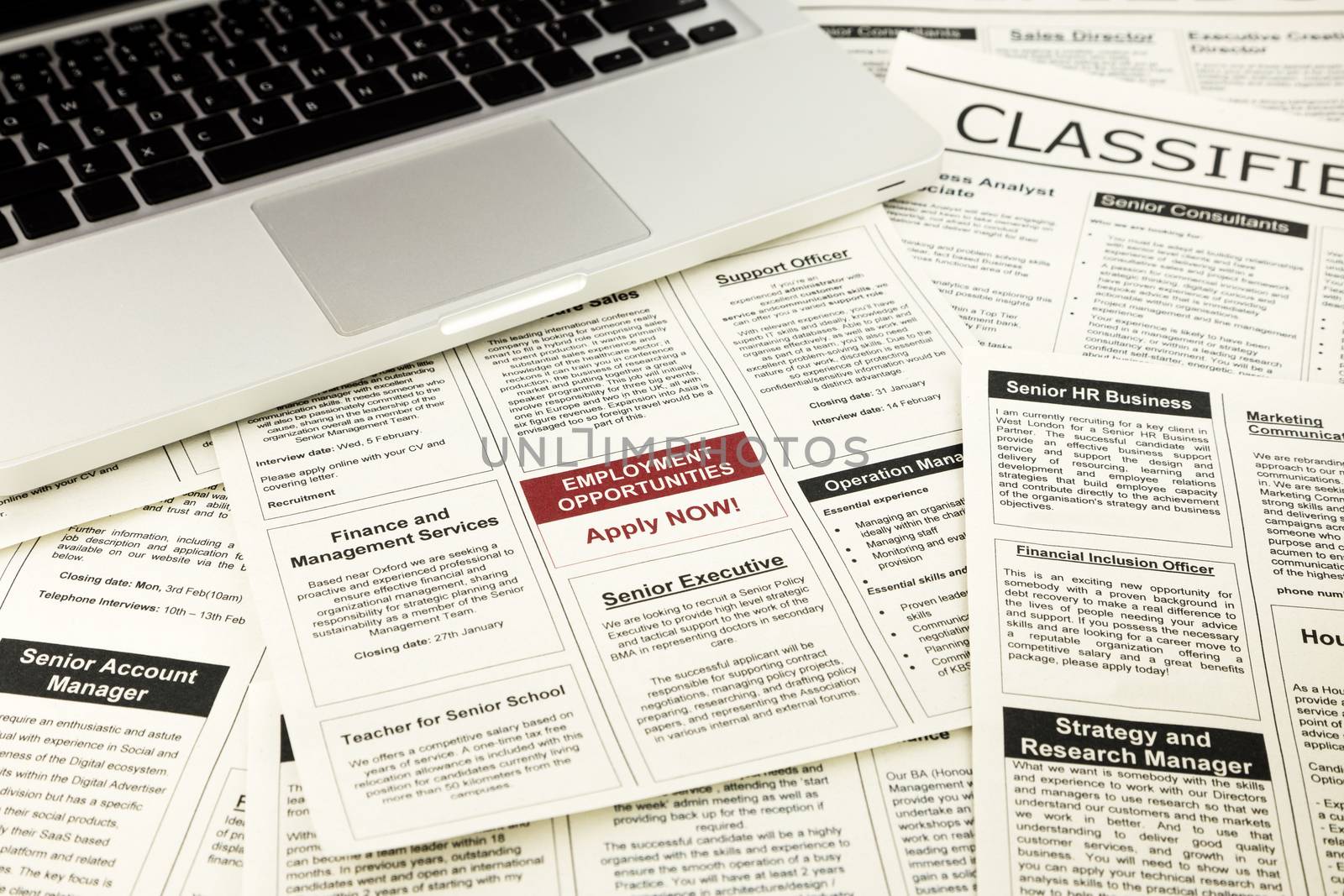 newspaper with advertisements and classifieds ads for vacancy, job search and apply now