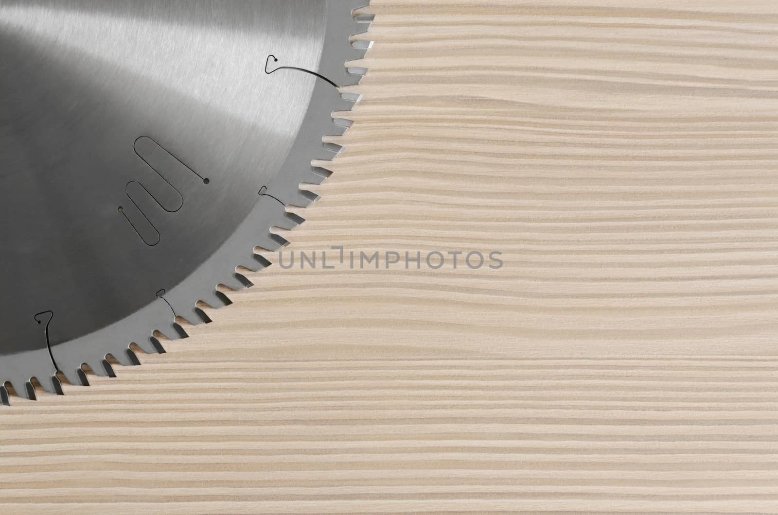 sharp circular saw on wood background bleached pine