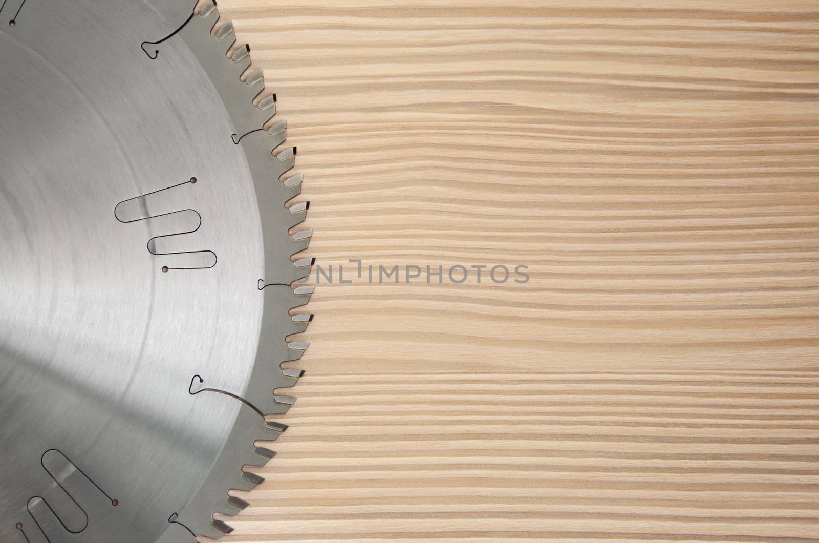 sharp circular saw on wood background bleached pine