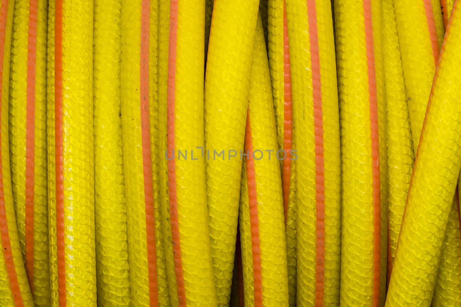 Yellow and orange water hose for watering gardens