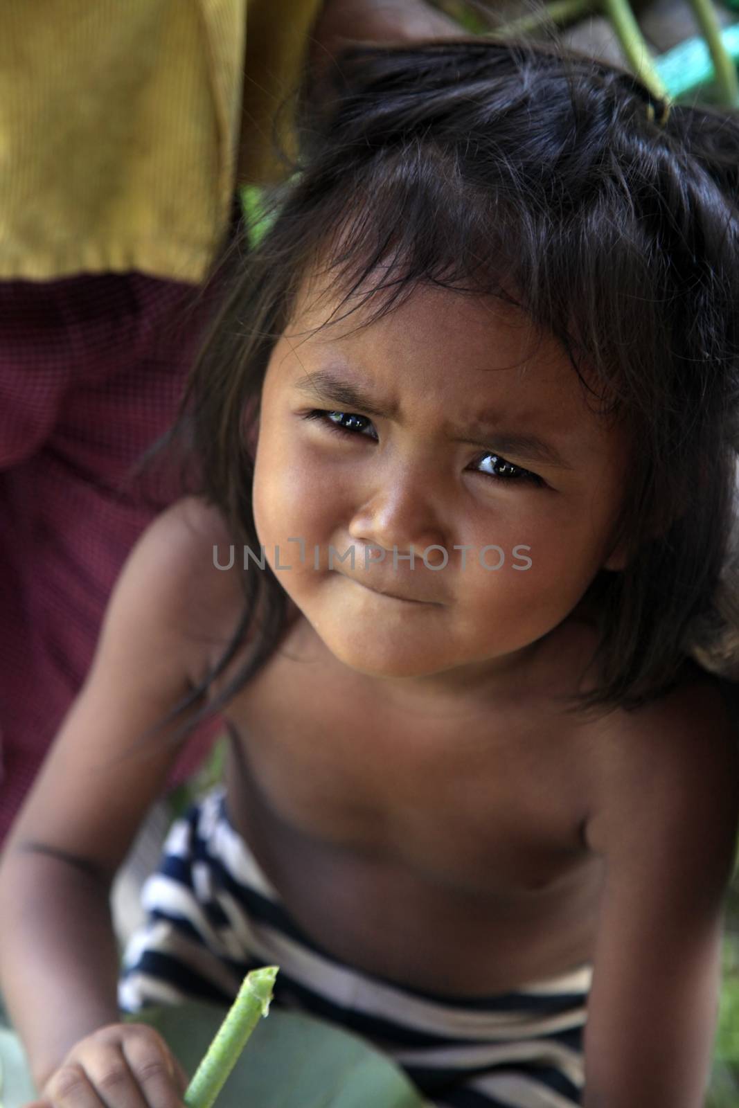 SIEM REAP, CAMBODIA - APRIL 06, 2014: unknown little girl in a poor village in Siem Peap 6 April 2014, Cambodia