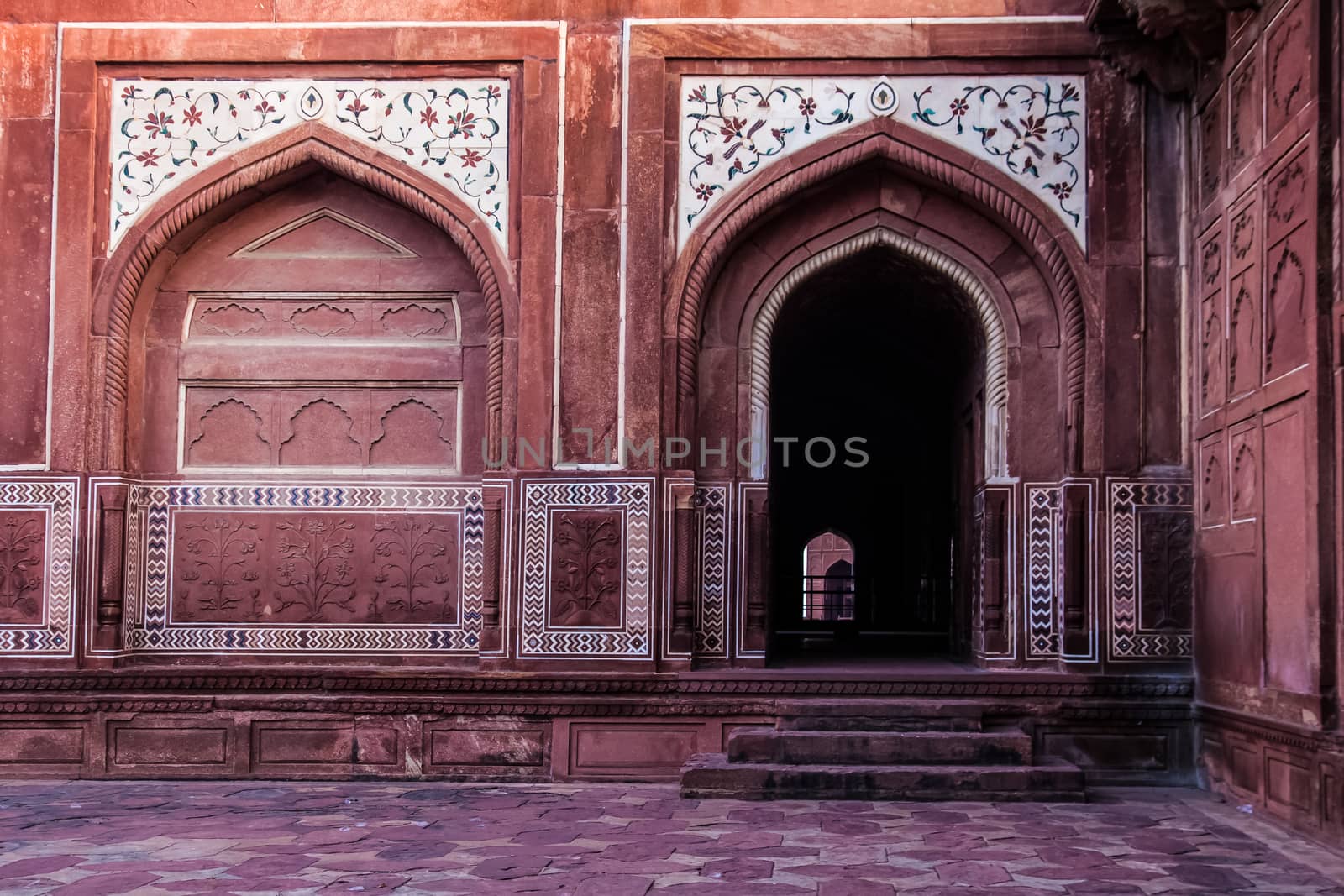 On Either side of Taj Mahal Lie these Buildings of Red Sandstone with Arches, Arched Doorways and courtyards. Contrasting red stone and white marble Inlay of various floral and geometric designs with coured stones as well aspanels with  basreliefs of floral designs