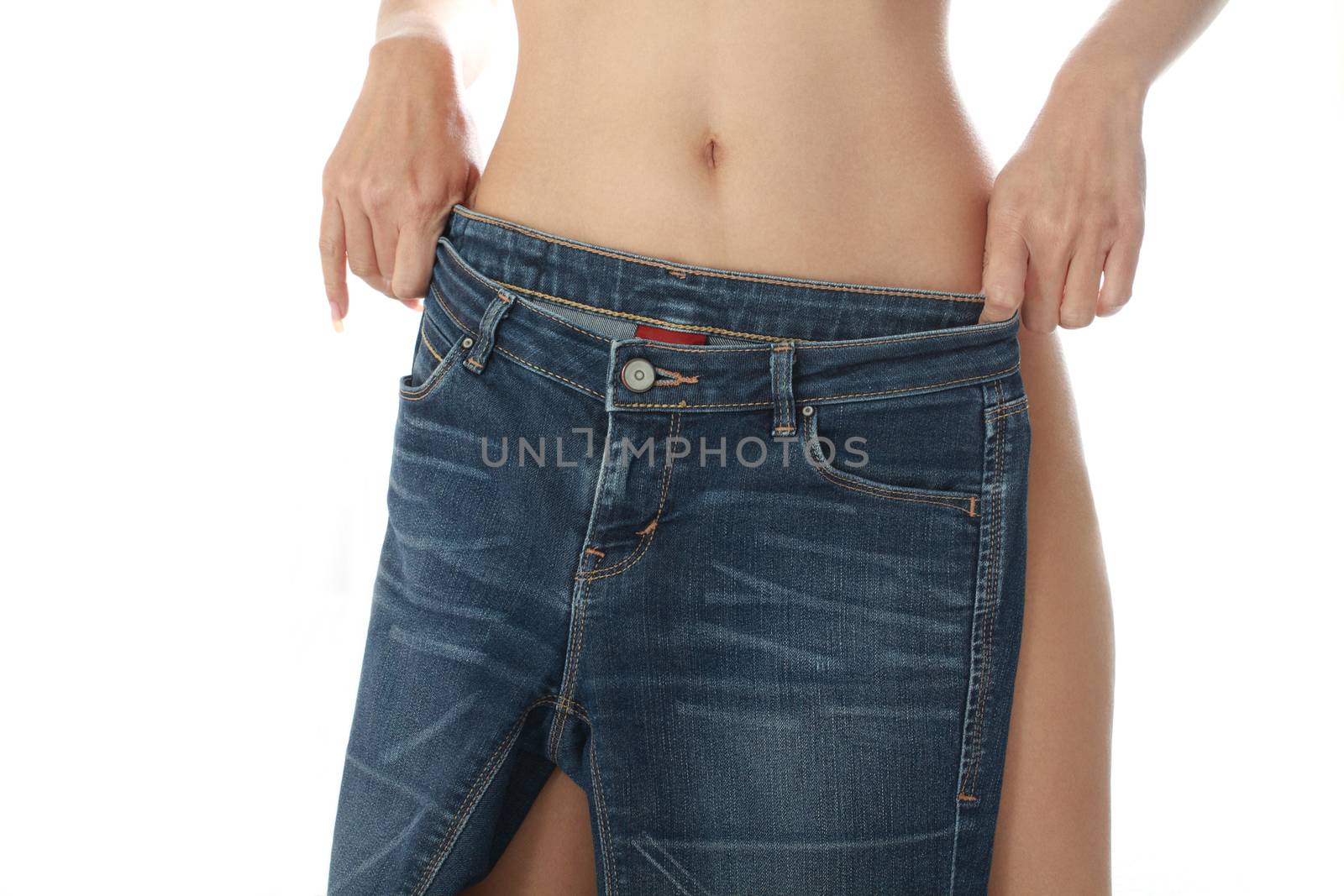 Sexy female take off jeans, isolated on white background.