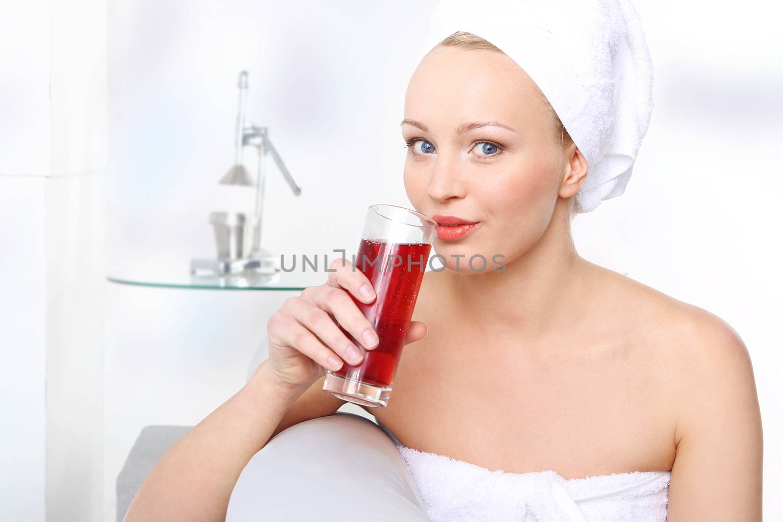 Young woman with a glass of fruit juice.