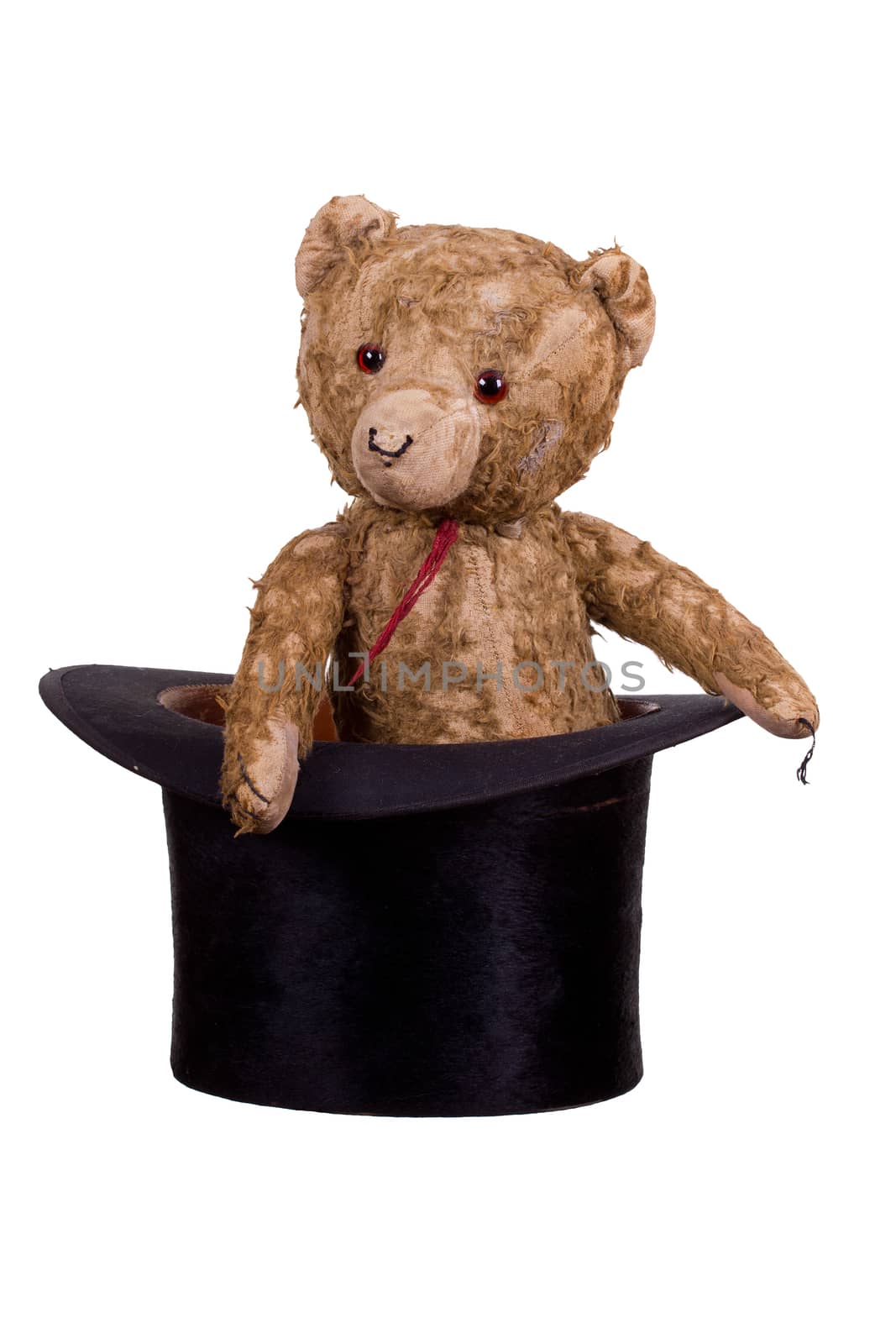 old teddybear sitting in old black hat