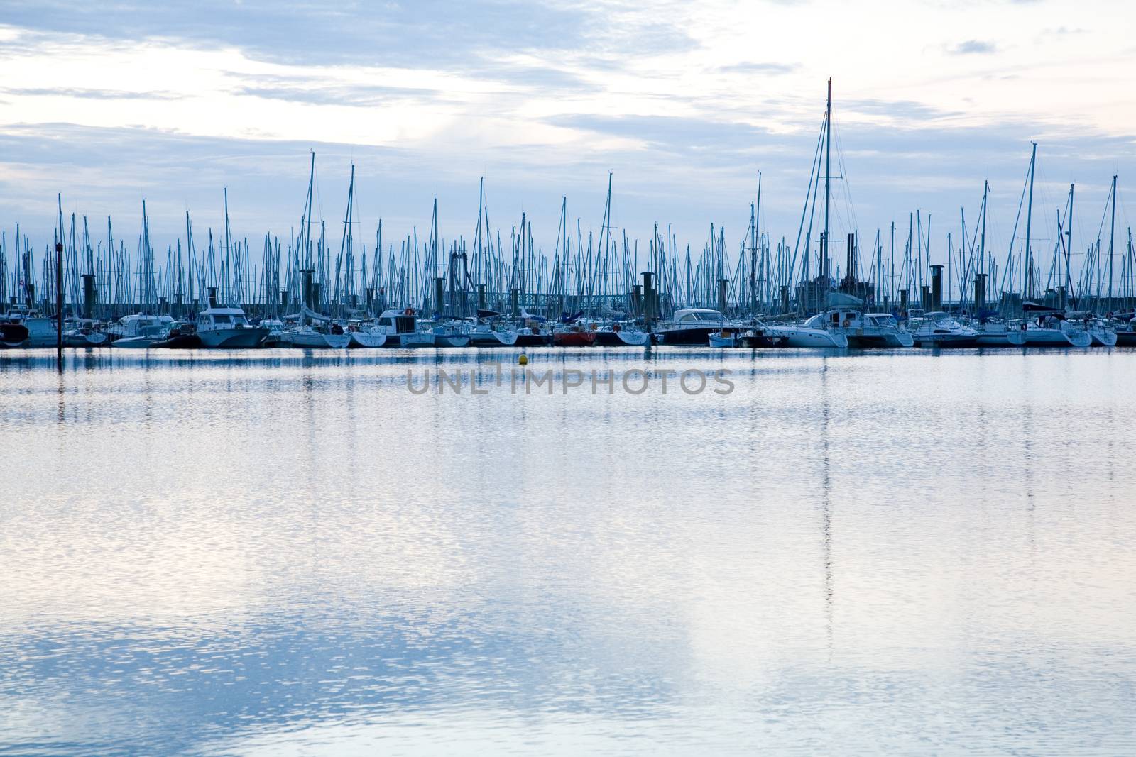 Masts of sailing boats moored in marina near Saint Malo