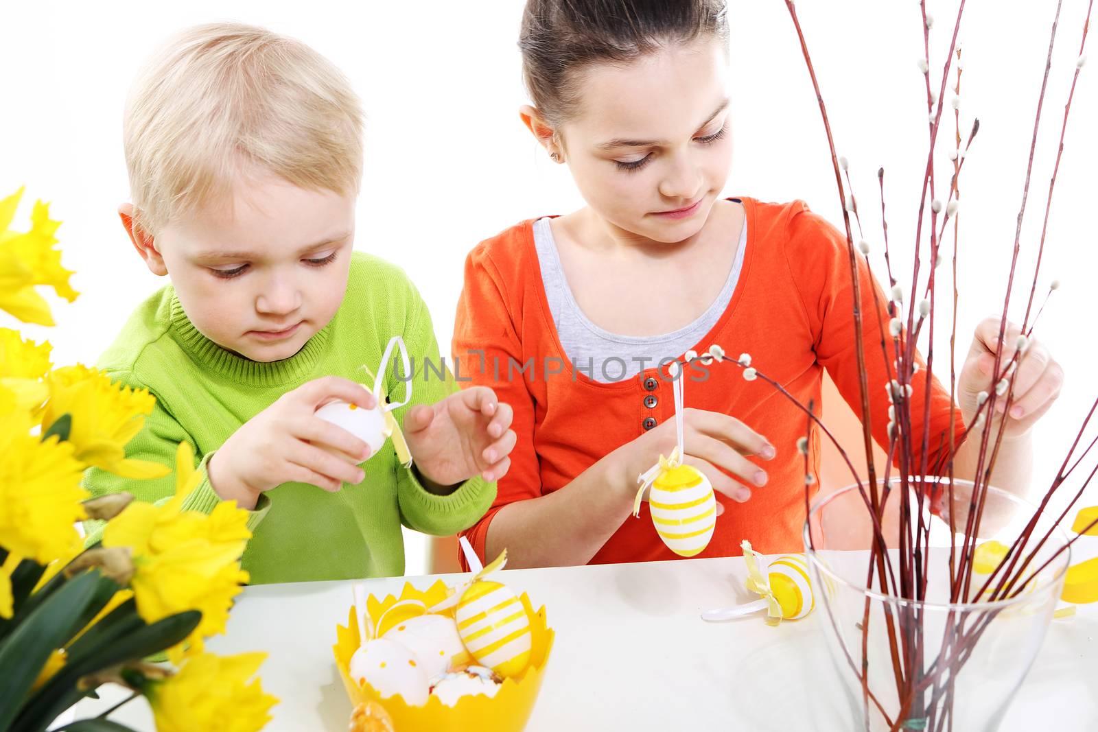 Children boy and girl painting Easter eggs