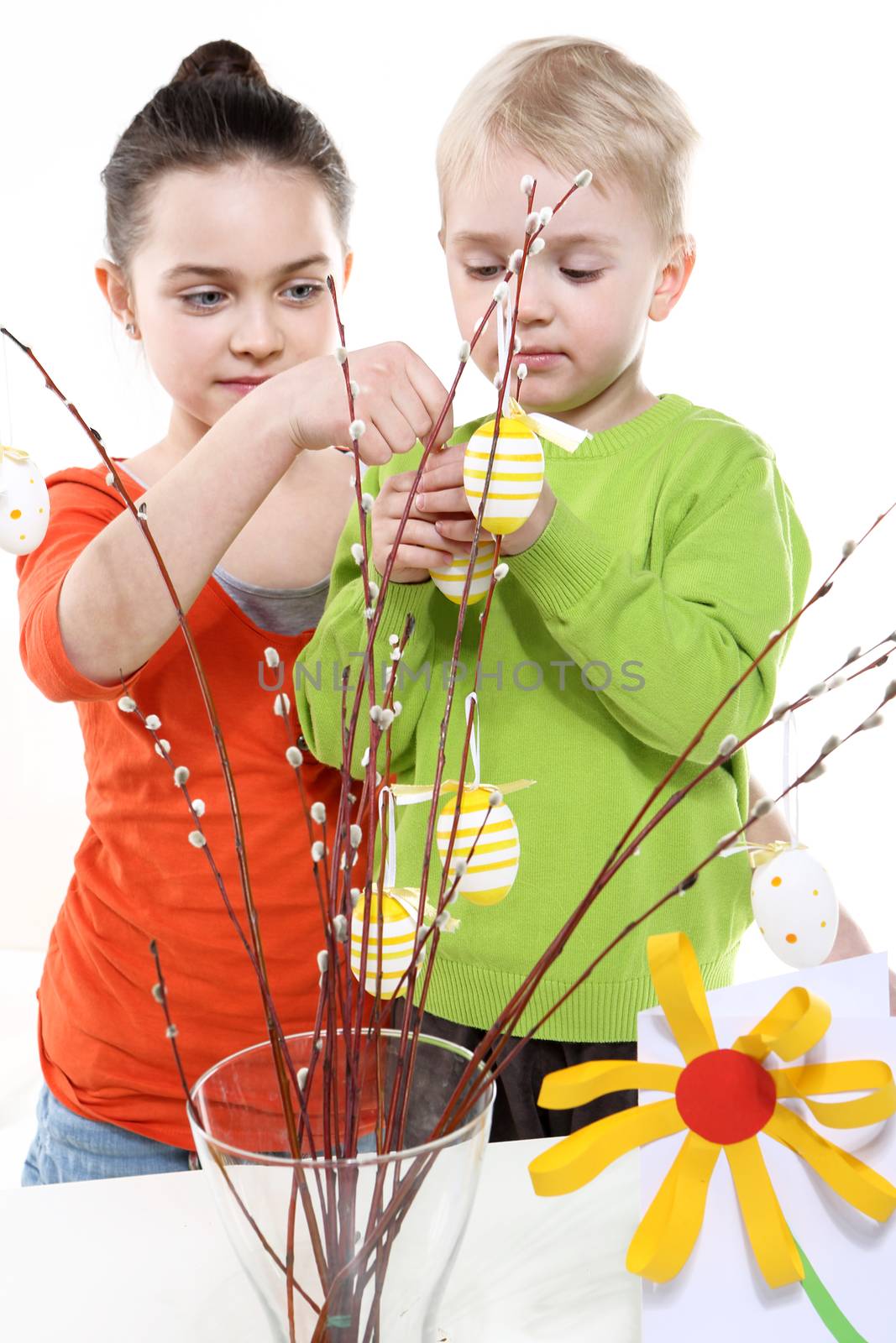 Children boy and girl painting Easter eggs