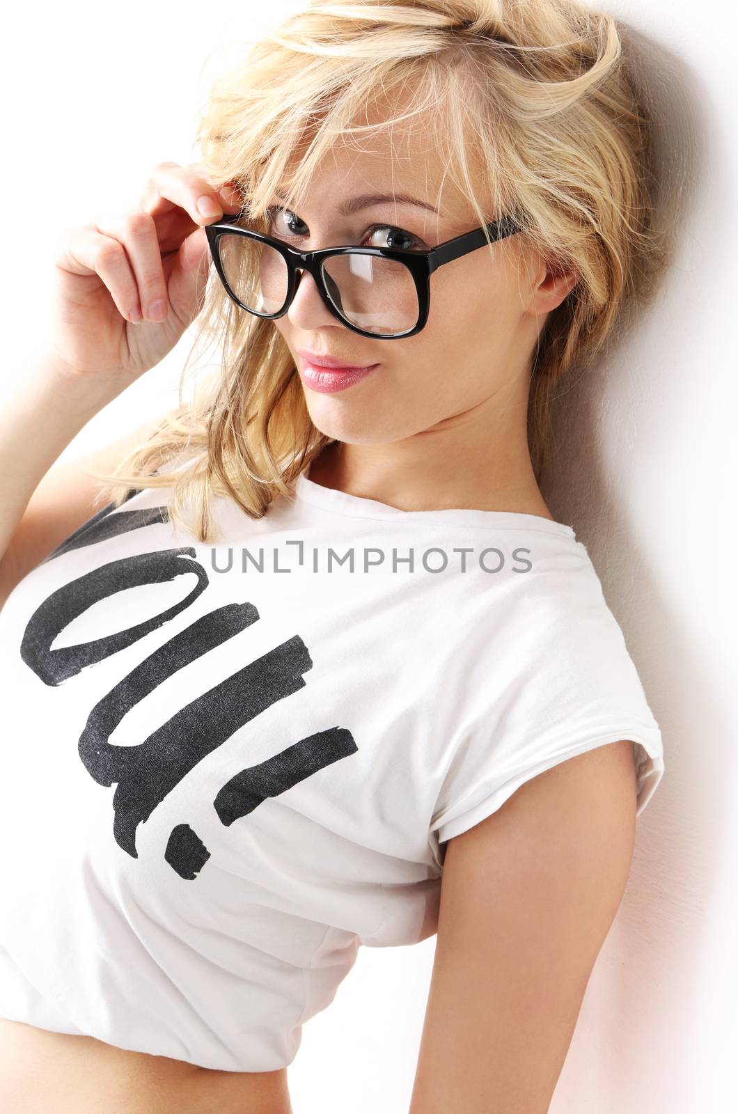 Sexy young woman based on a white wall in a T-shirt with the words You