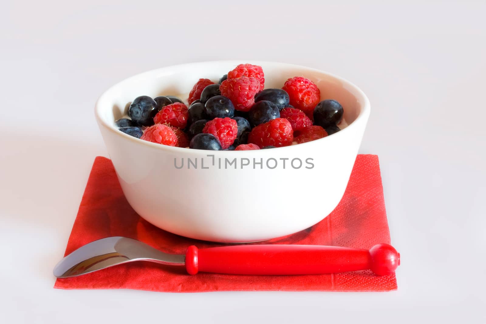 Bowl with berries on a white background