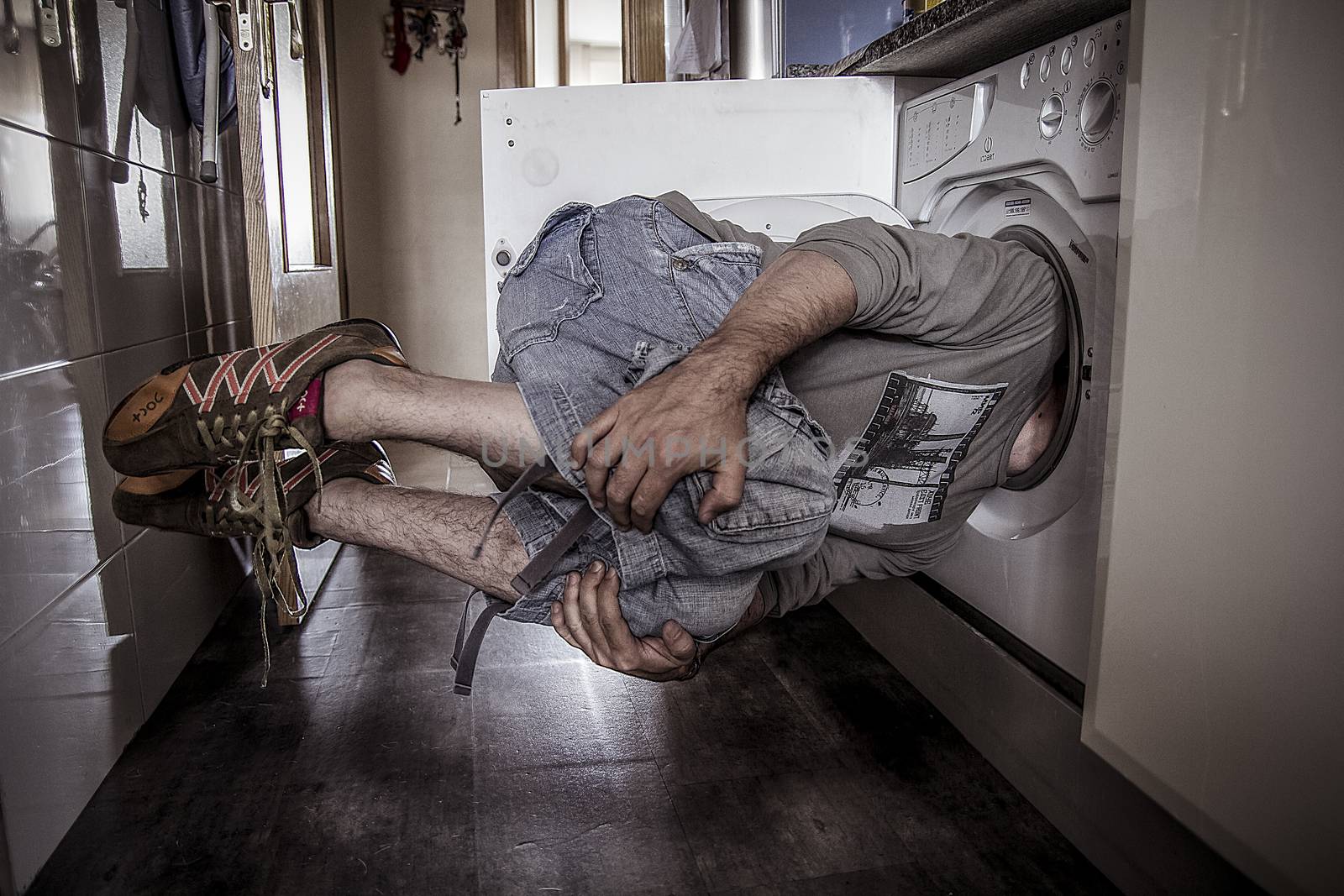 man flying with his head stuck in a washing machine