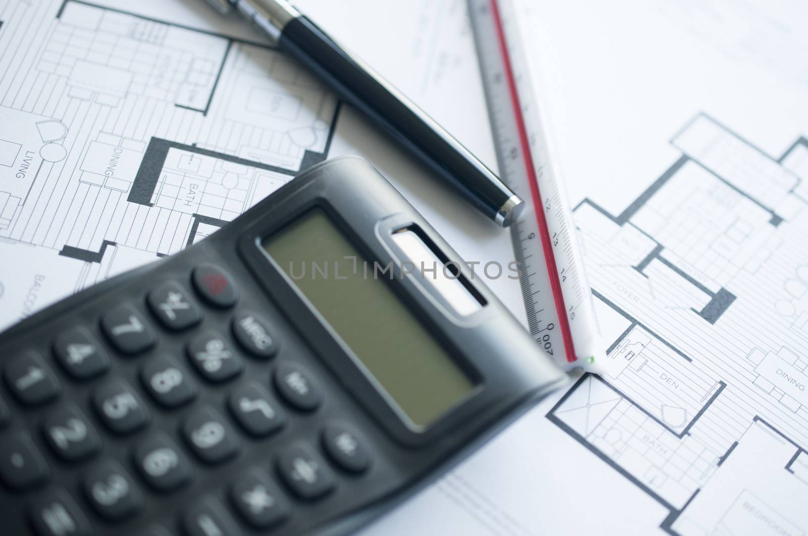 Architect with calculator and plan, pencil and ruler 