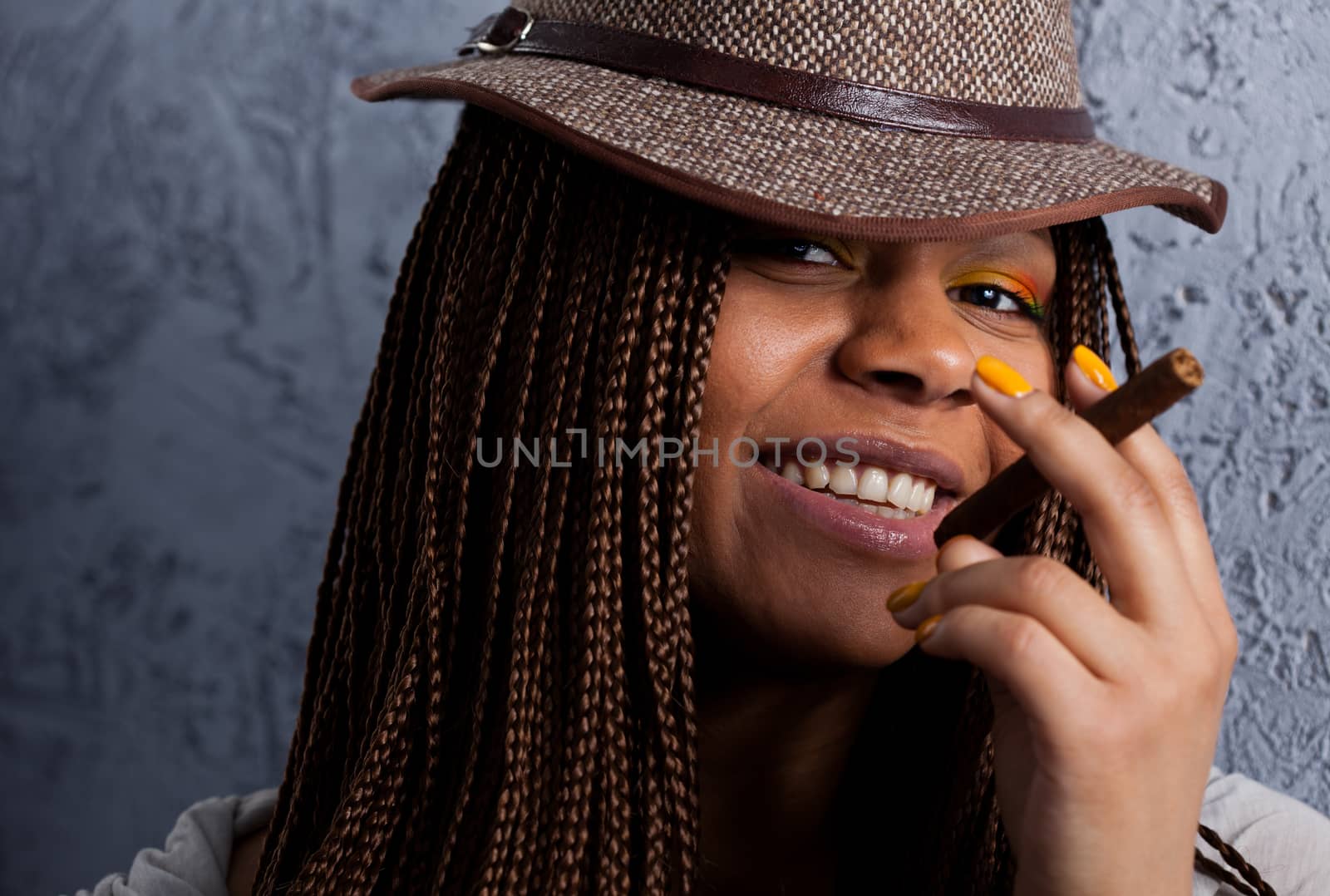 close-up portrait of a black young woman with a cigar