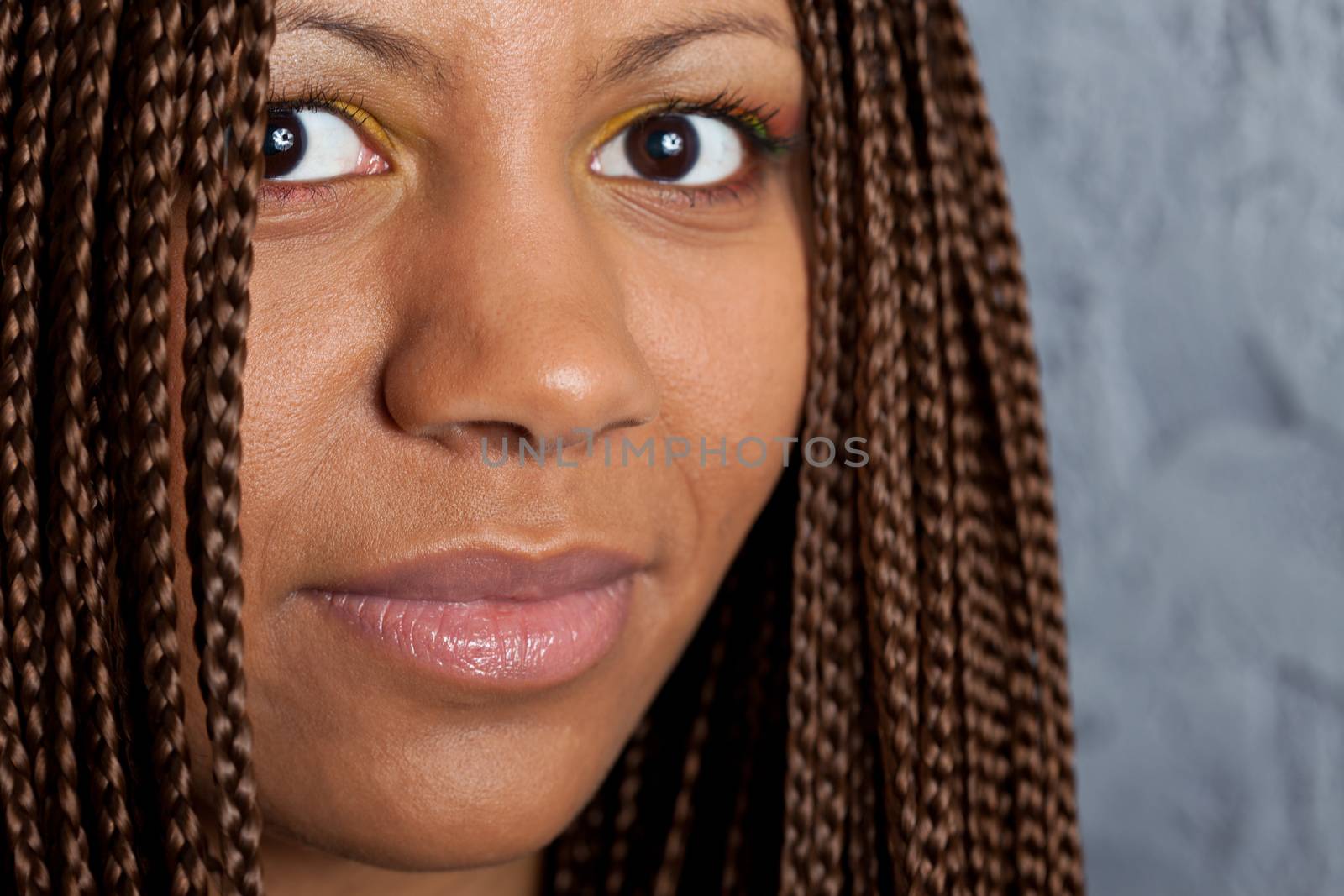 close up portrait of a young woman with African braids