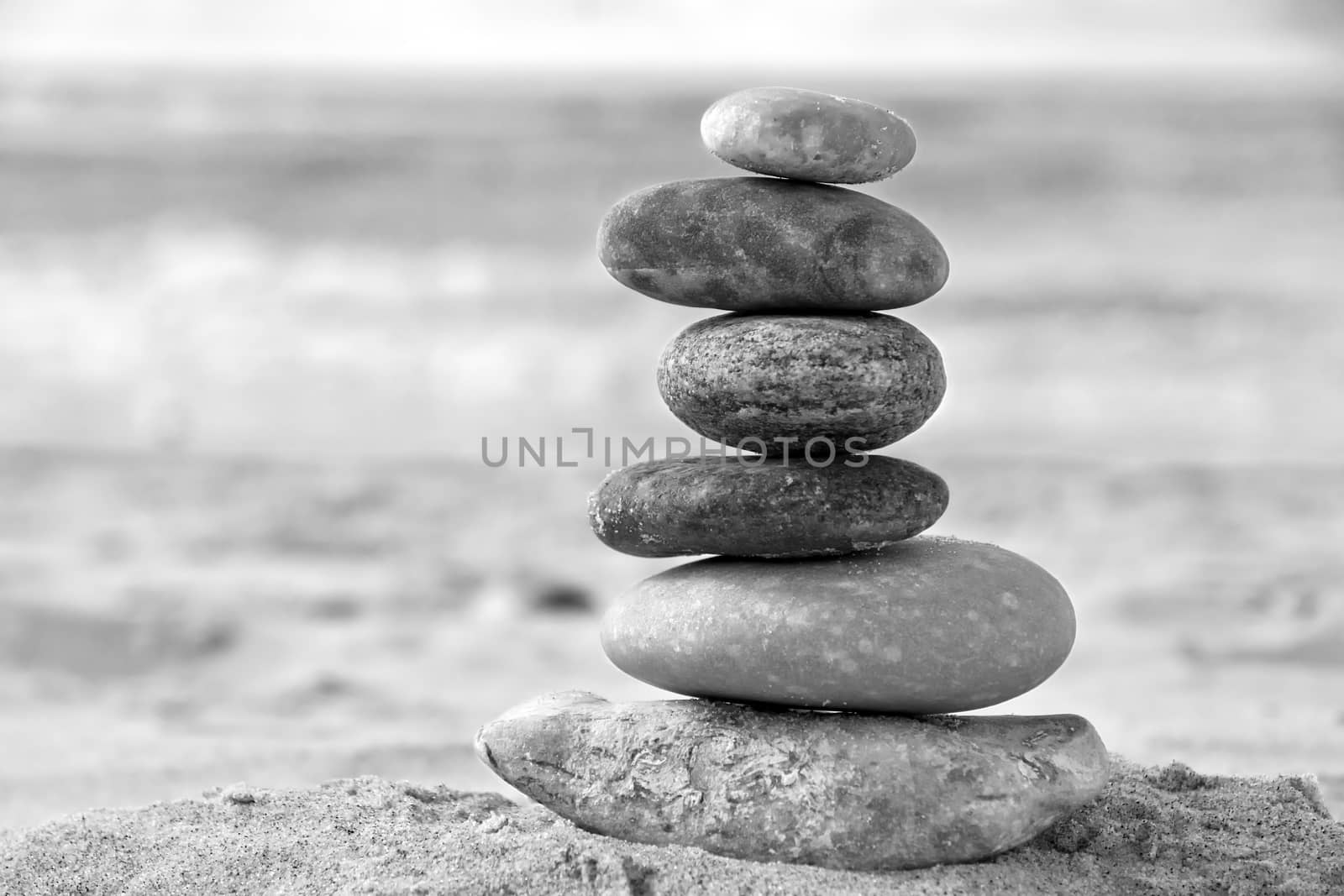 A composition of stacked stones on the beach.