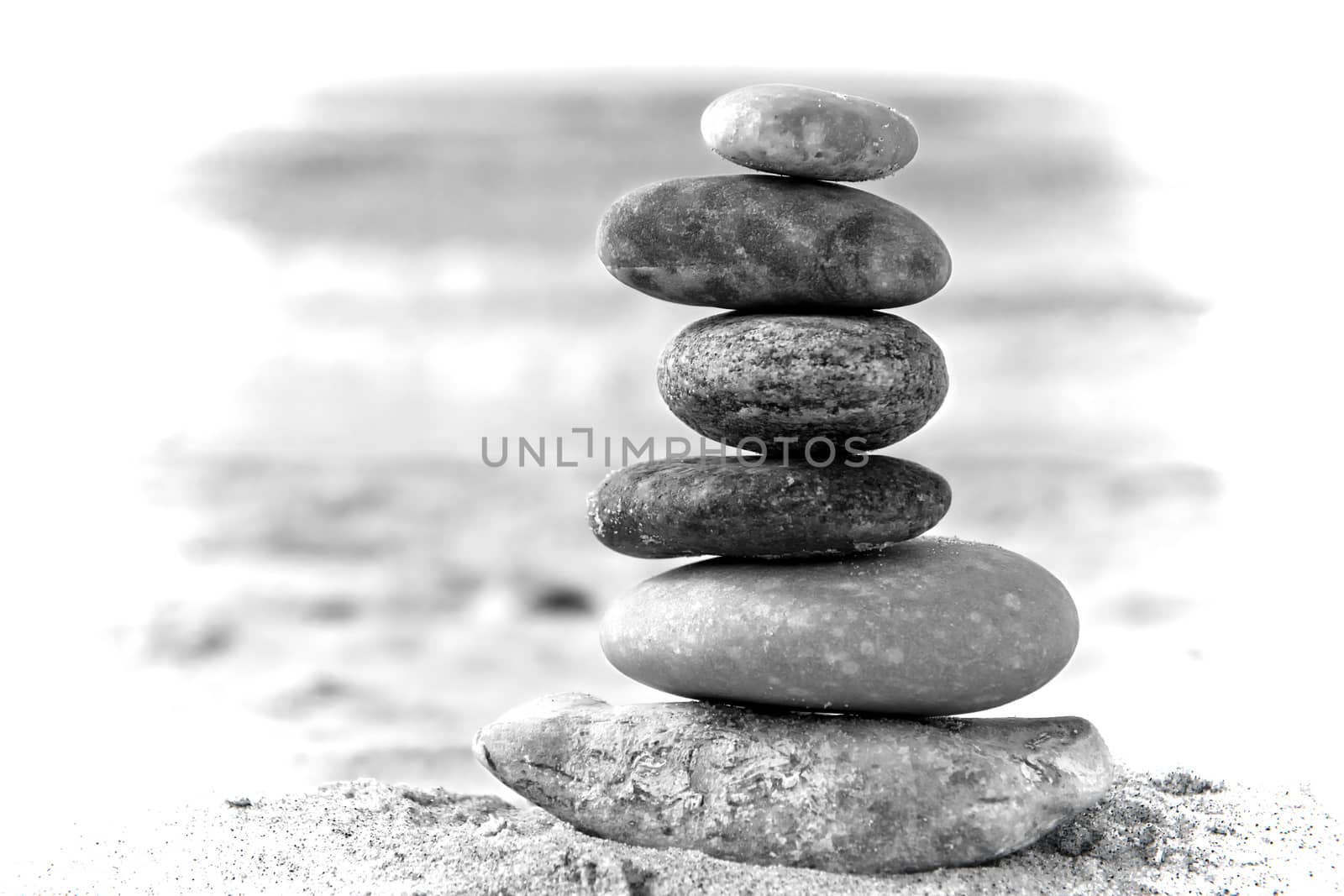 A composition of stacked stones on the beach.