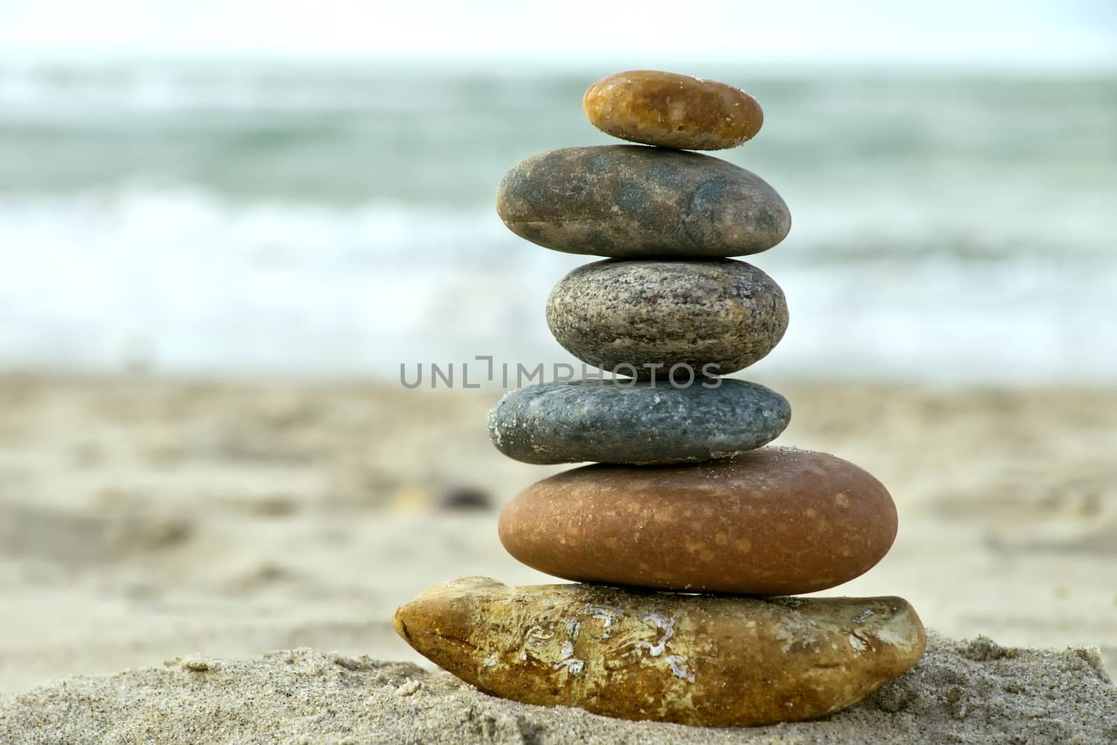 A composition of stacked stones on the beach.