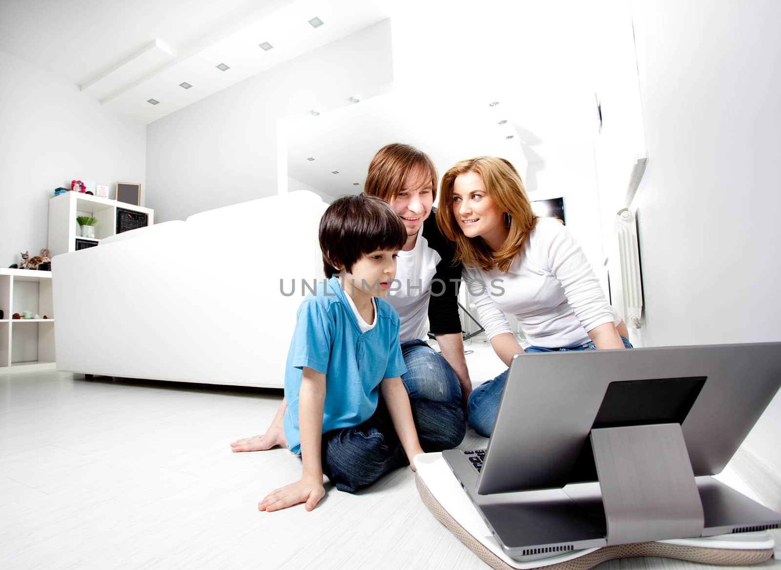 Young parents with child near laptop computer