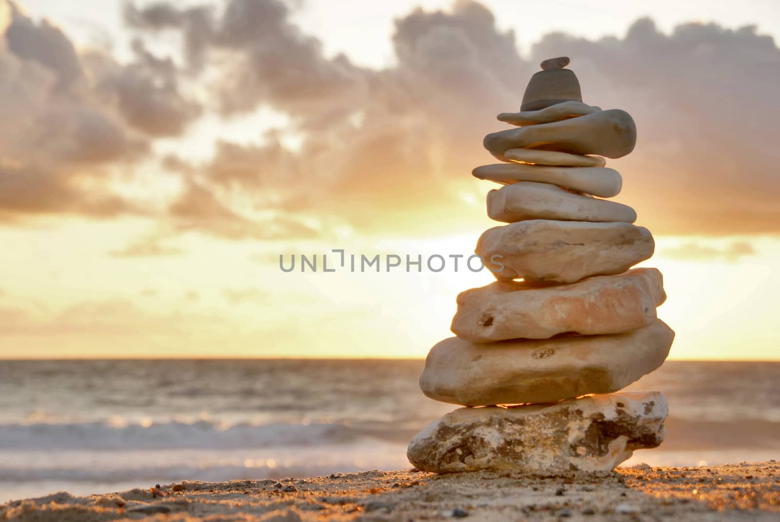 A composition of stacked stones on the beach.