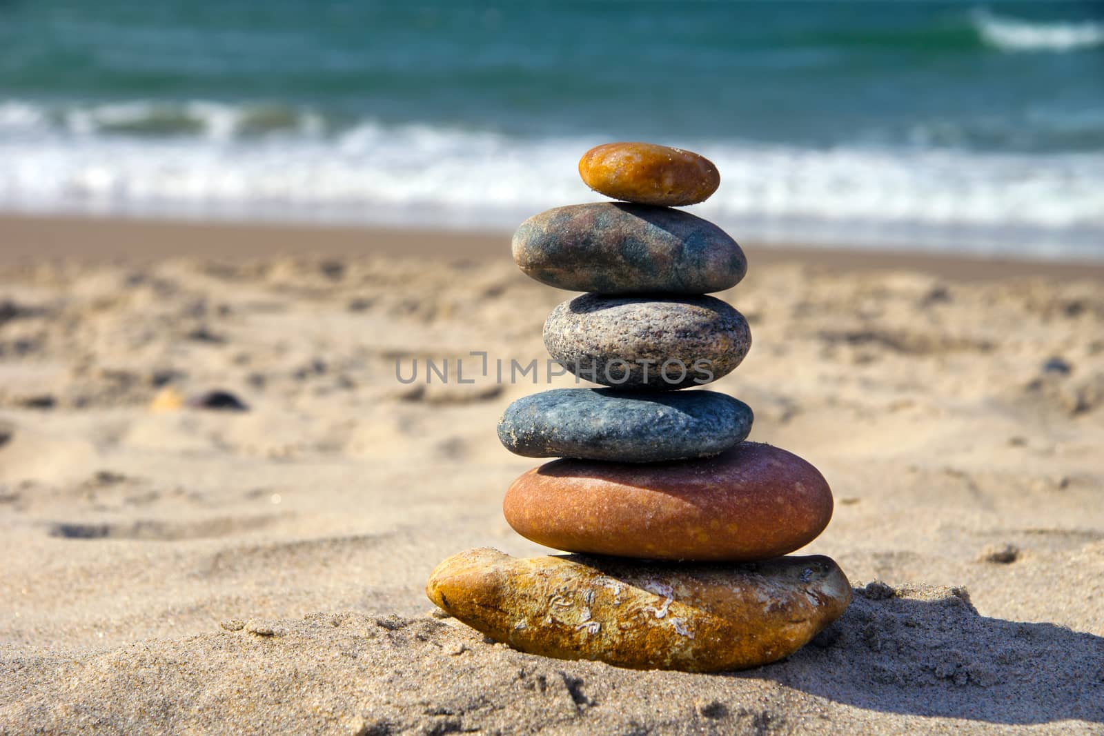 A composition of stacked stones on the beach.