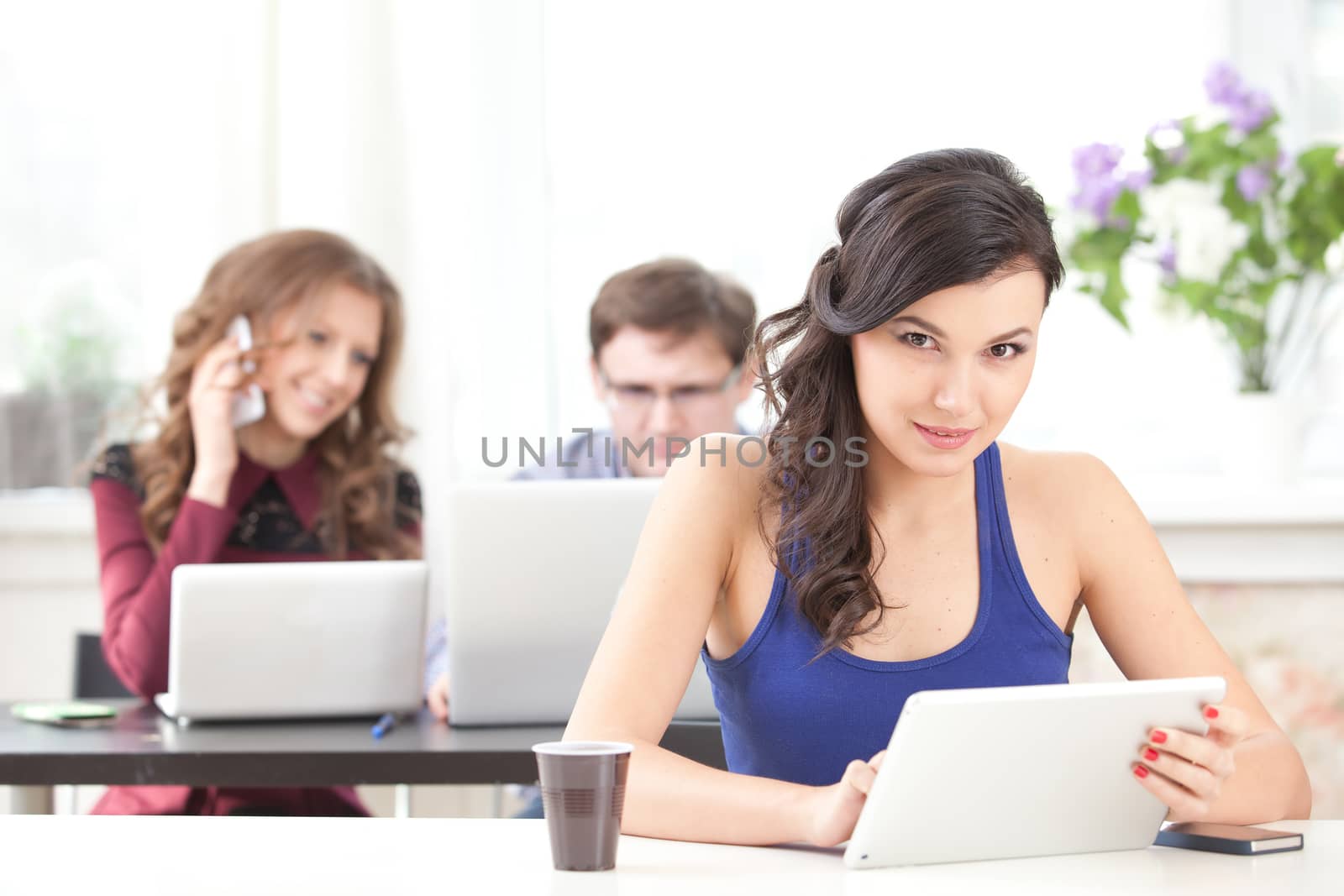 smiling young girl reading tablet at school