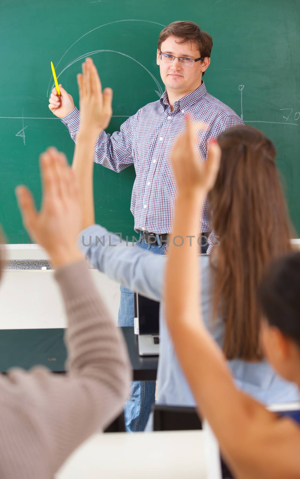 Teacher at university in front of a chalkboard