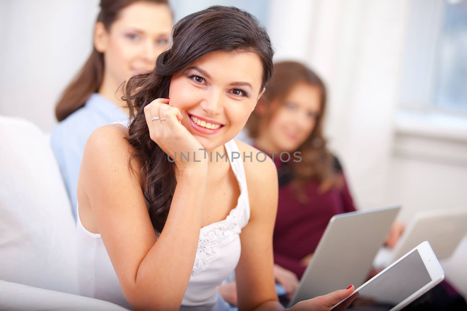 smiling young girl reading tablet at school