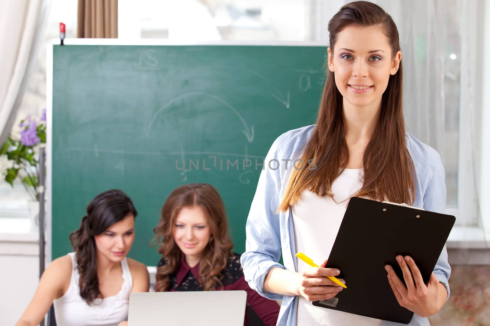 Portrait of smiling pretty girl looking at camera in college