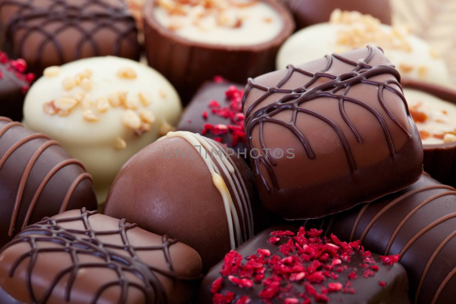 An assortment of fine chocolates in white, dark, and milk chocolate.  