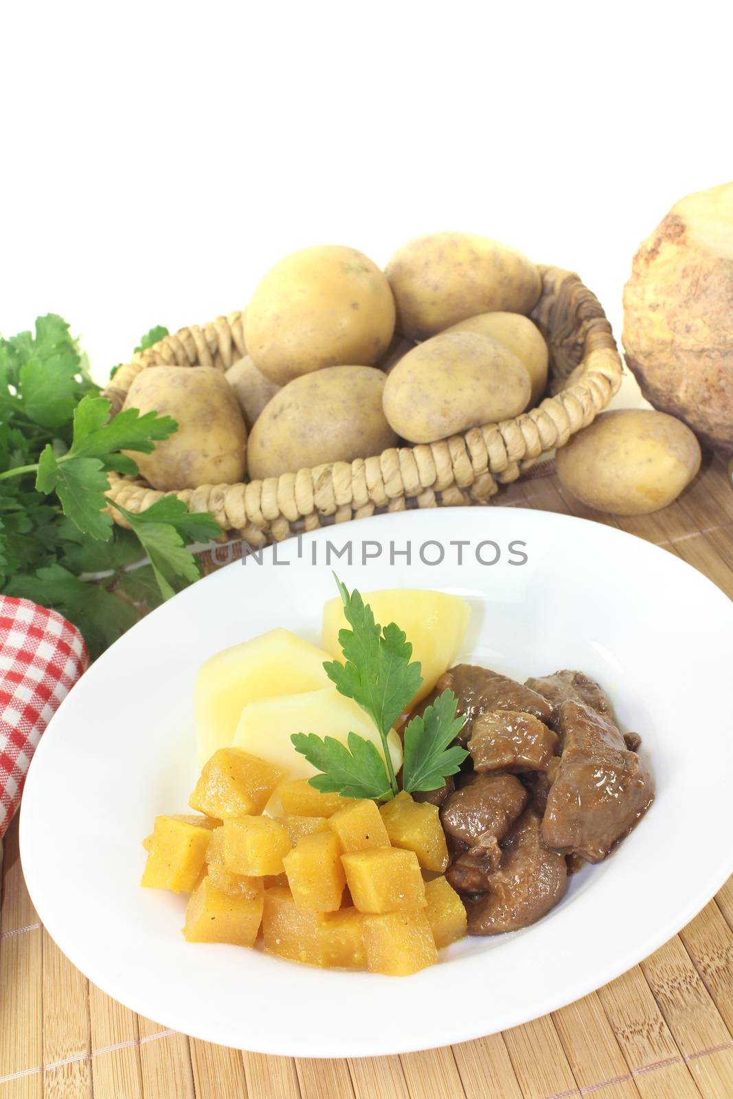 Venison goulash with turnip on a light background