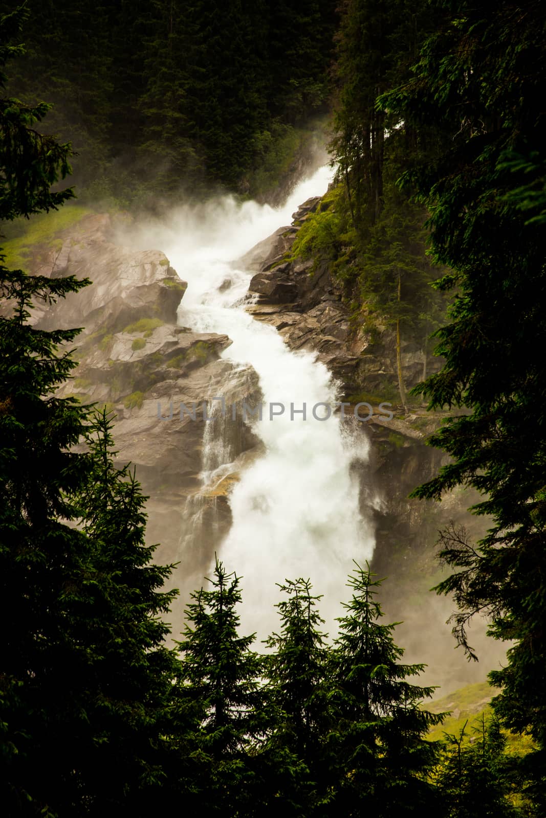 Very strong waterfall in high Alps mountains
