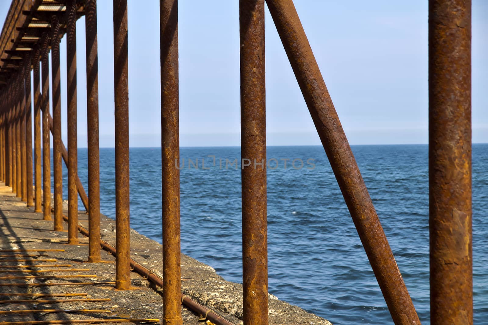 A rusty railing on a pier on the North Sea.