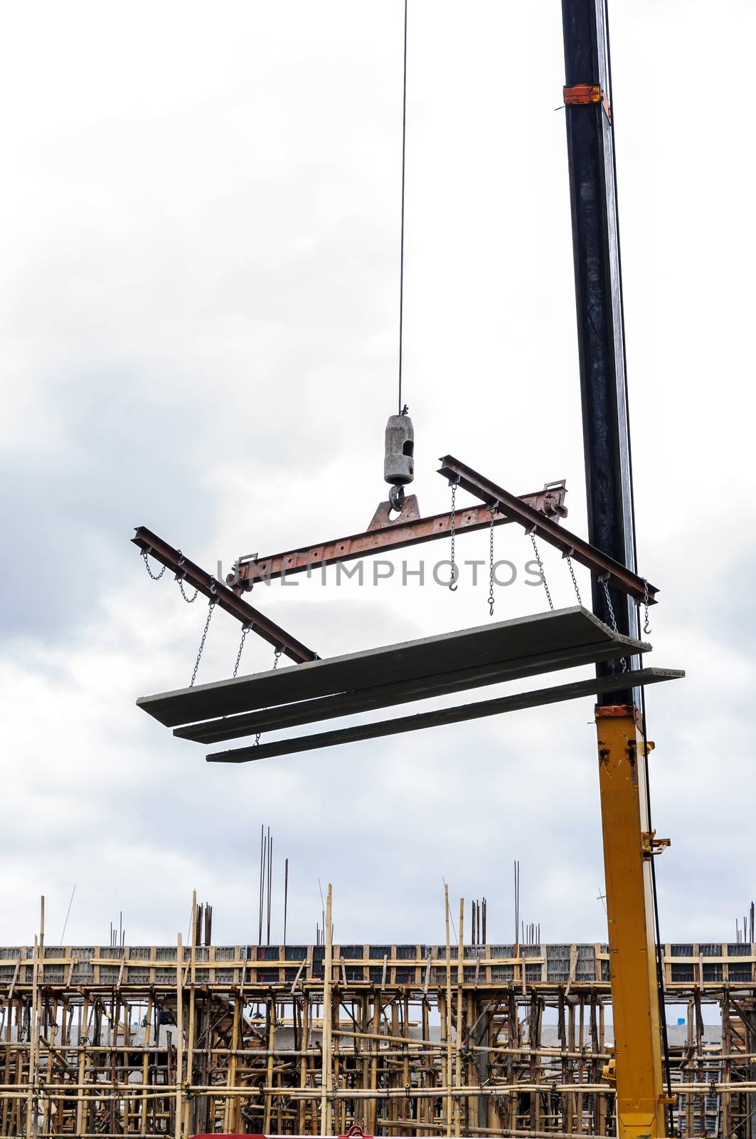 Crane hoist concrete plate by NuwatPhoto