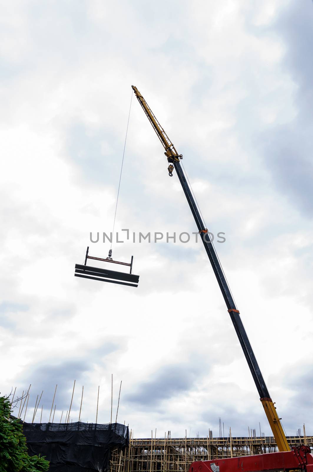 Crane hoist concrete plate at construction site