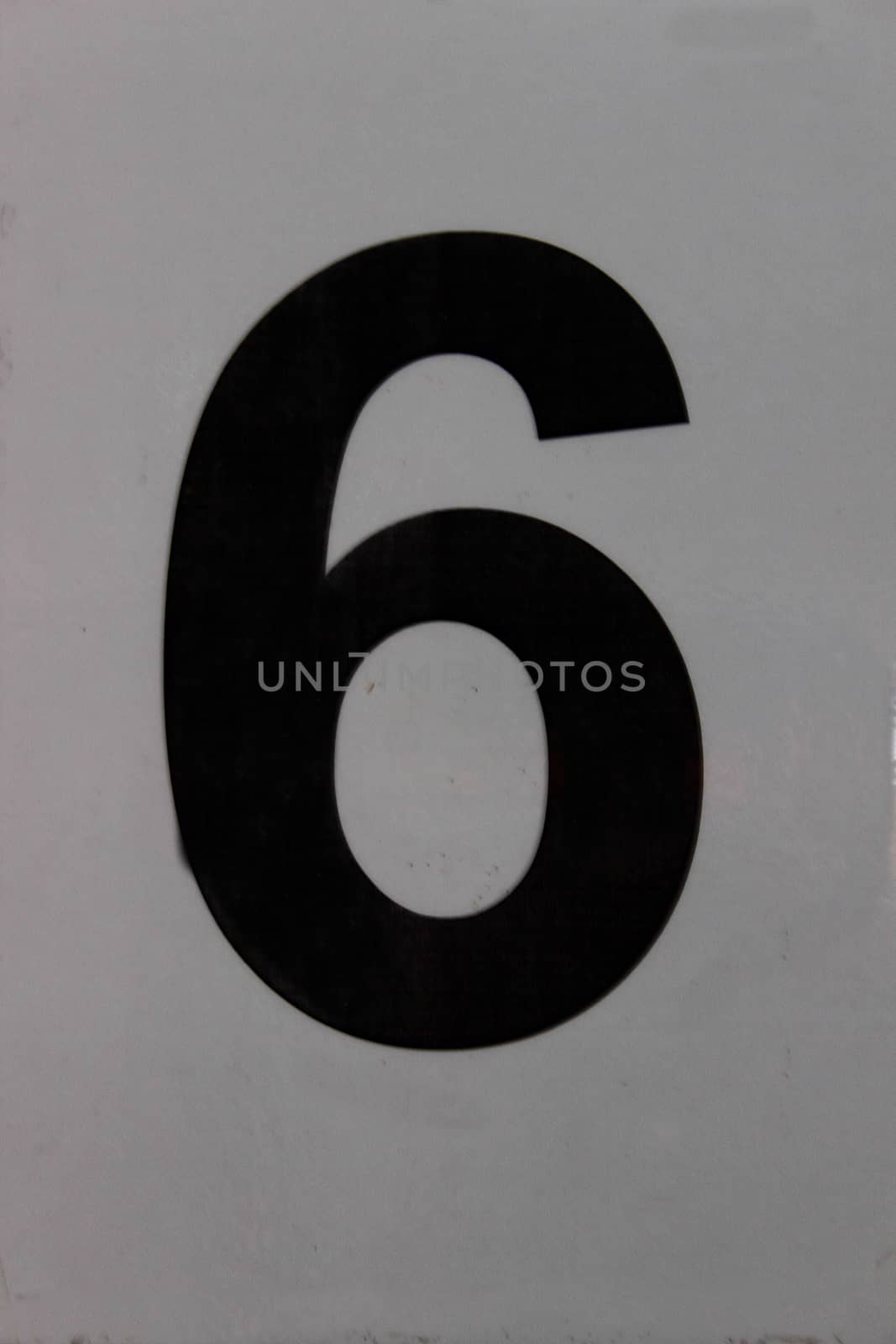 black displayed number six on a gray background