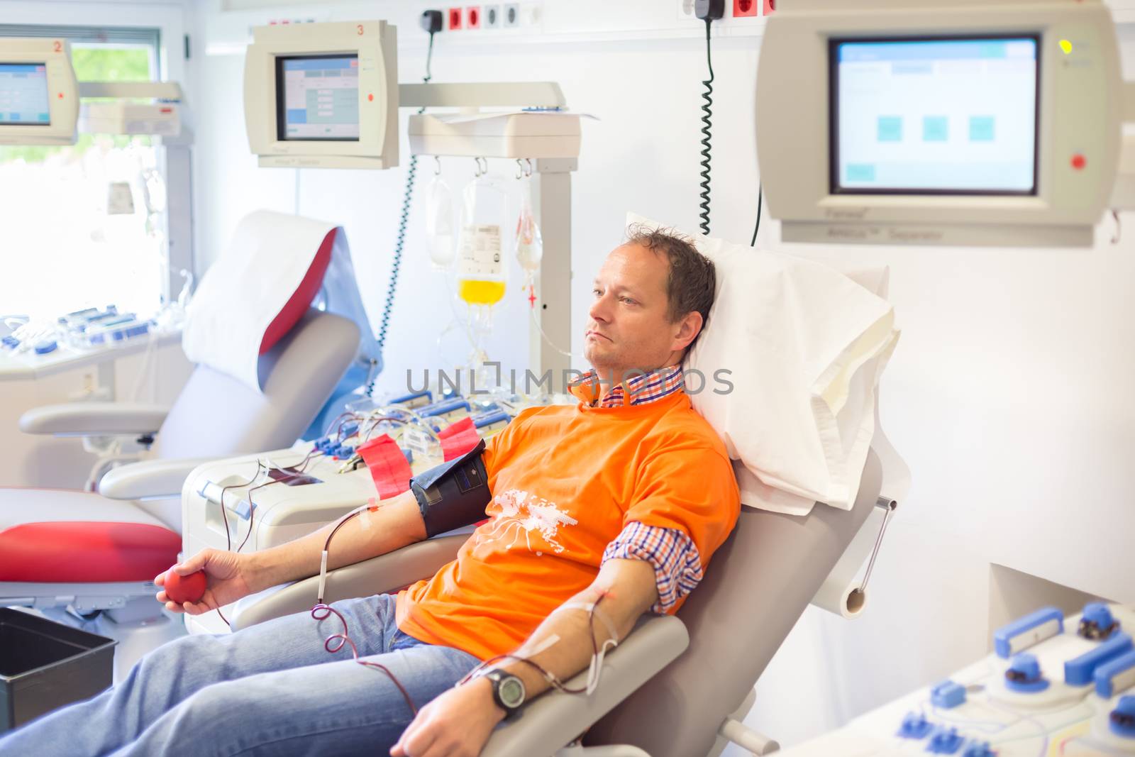 Blood donor at donation with a bouncy ball holding in hand.