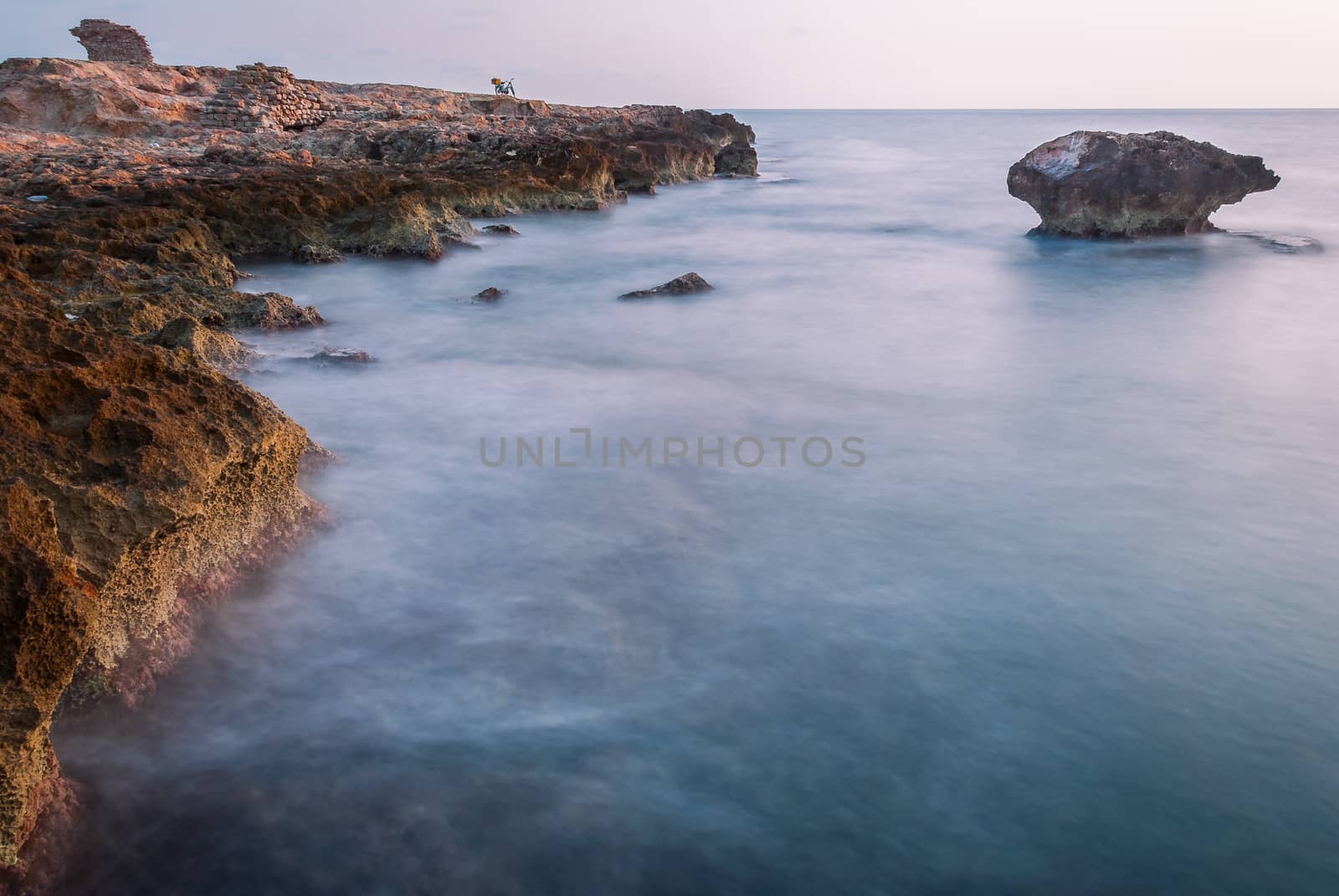 rock reef in the sea at sunset