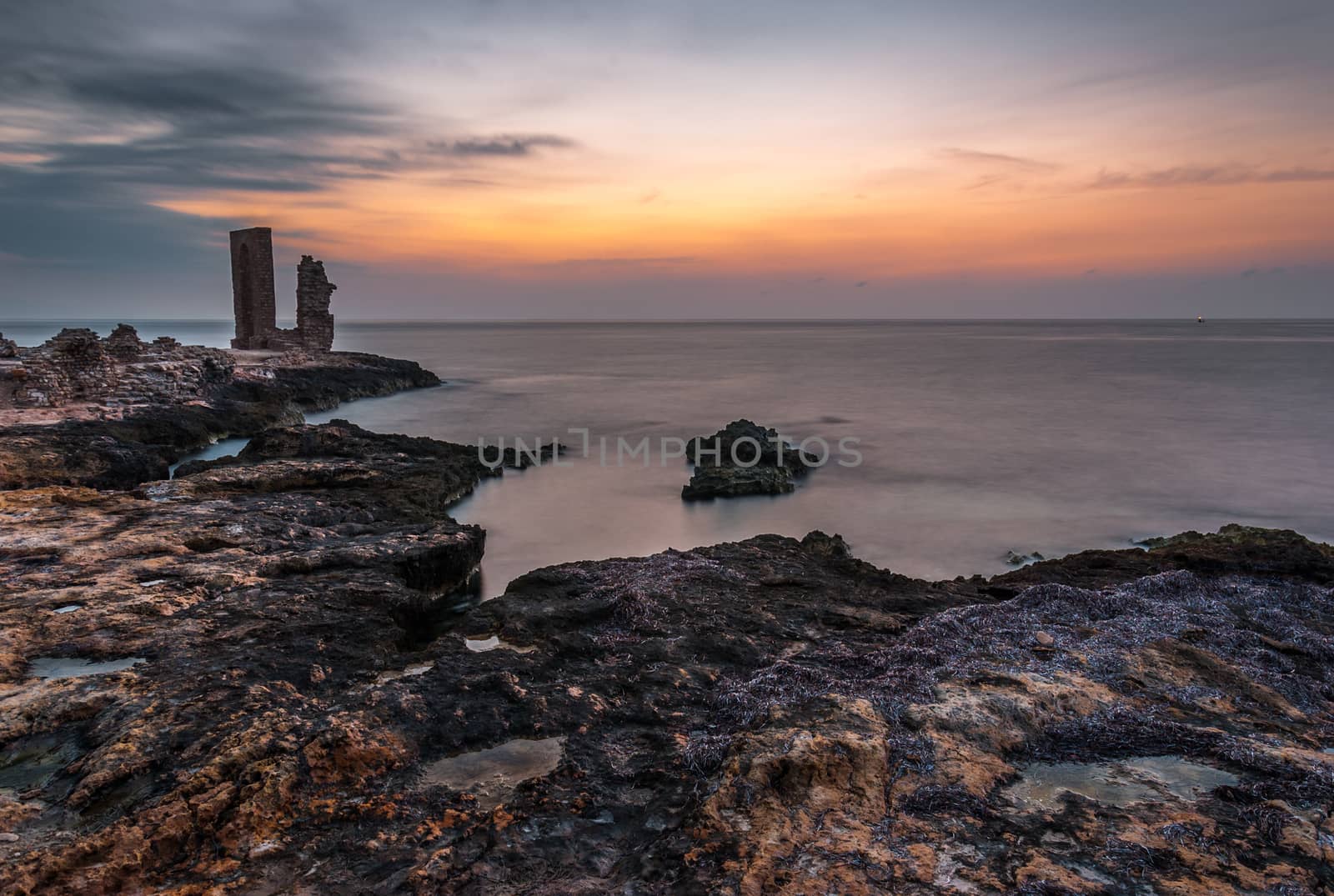 Sunset over the Sea and Rocky Coast with Ancient Ruins and Gate to Africa in Mahdia, Tunisia