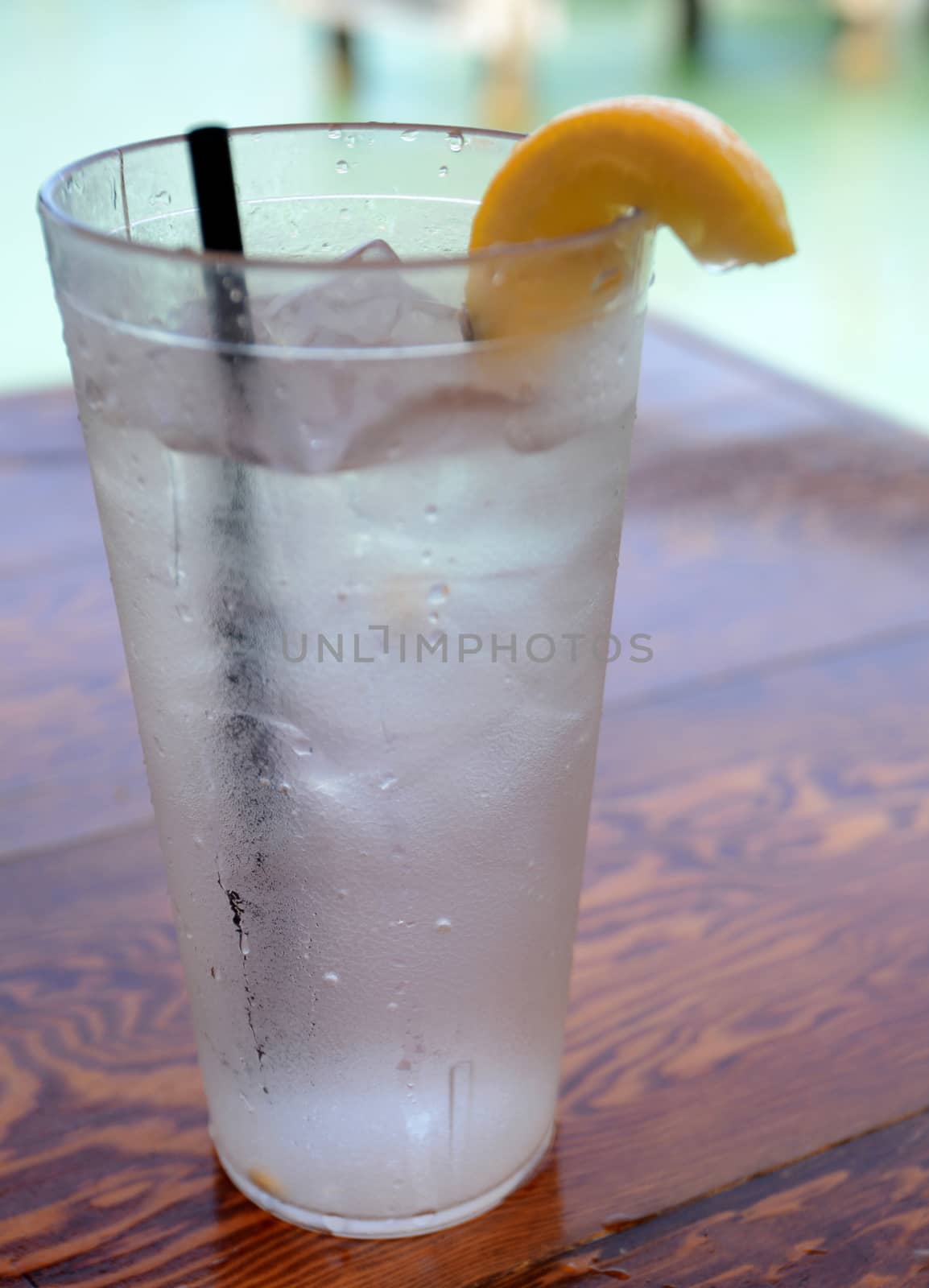 ice water on a wooden table with lemon