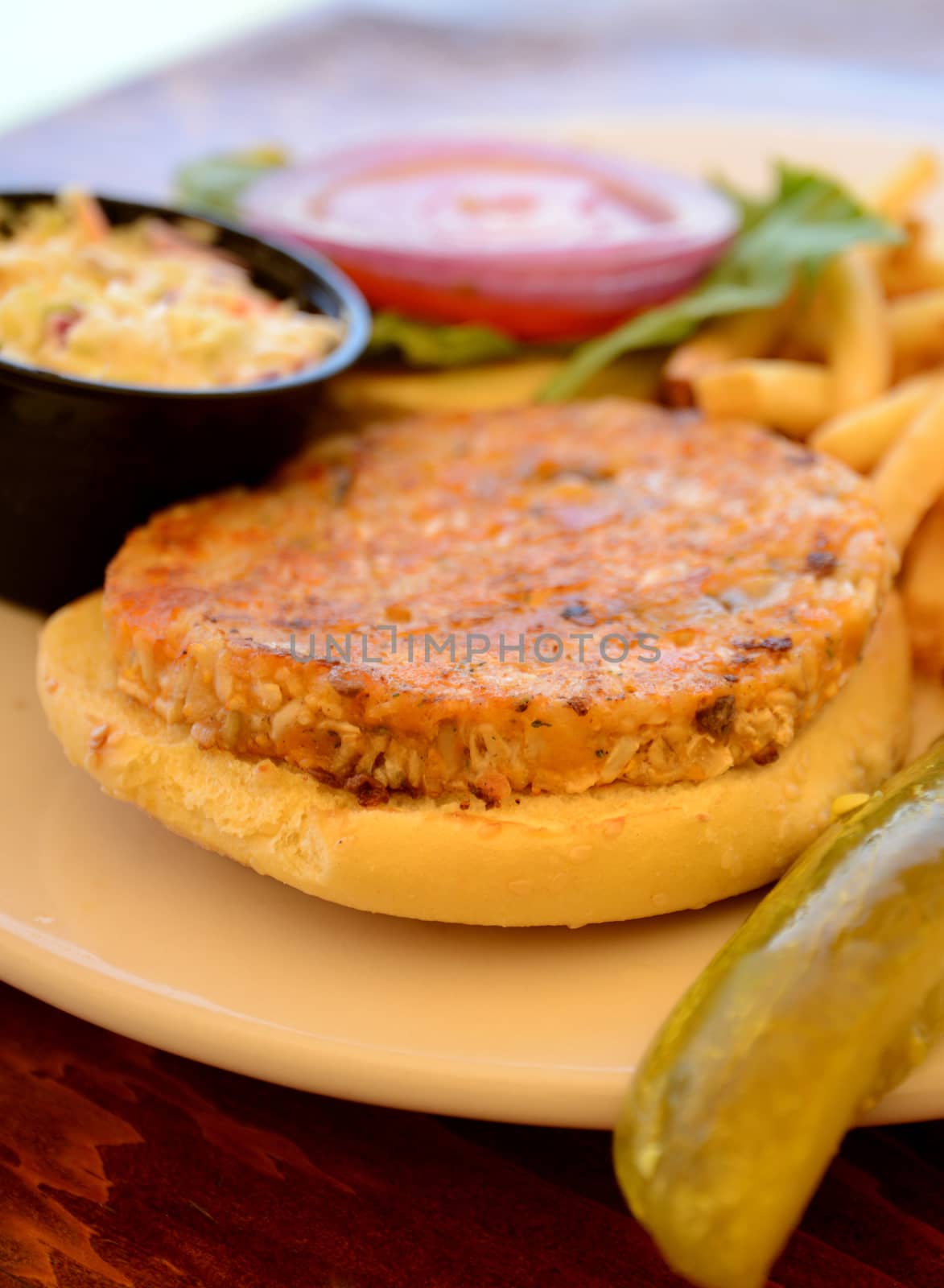 veggie burger with fries and a pickle