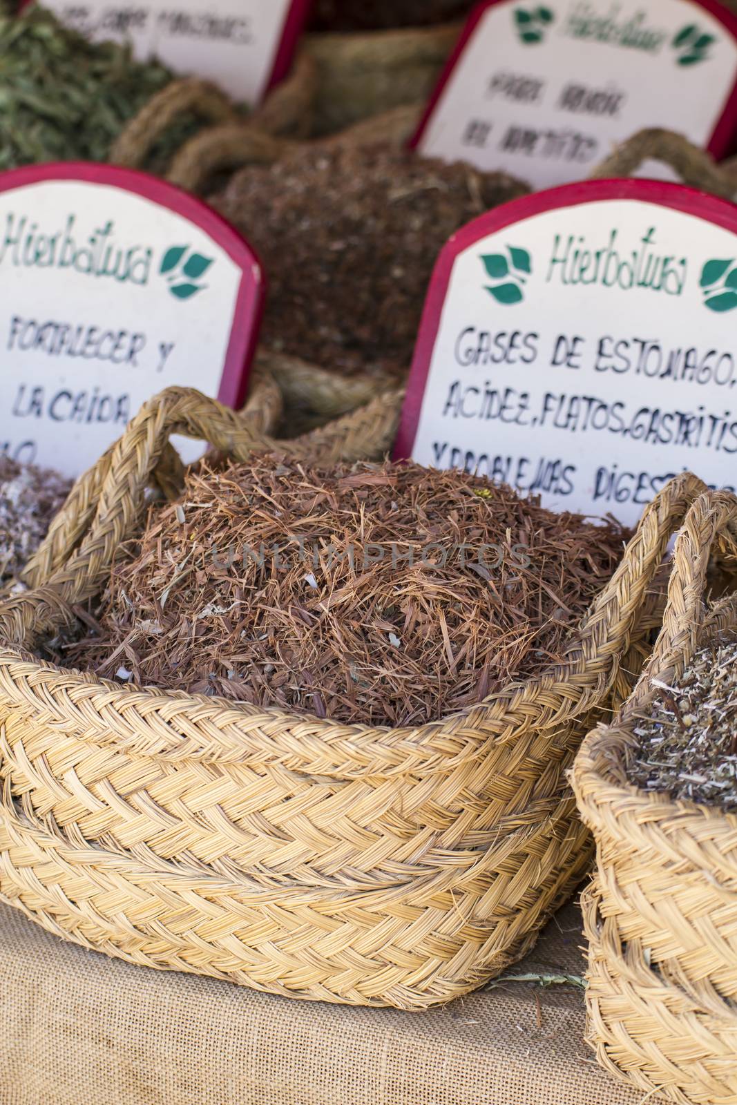 Apothecary, wicker baskets stuffed medicinal healing herbs