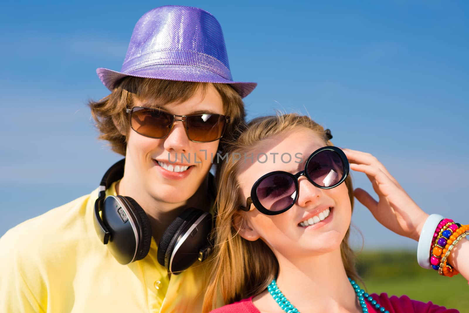 young couple standing on the road, having fun with friends