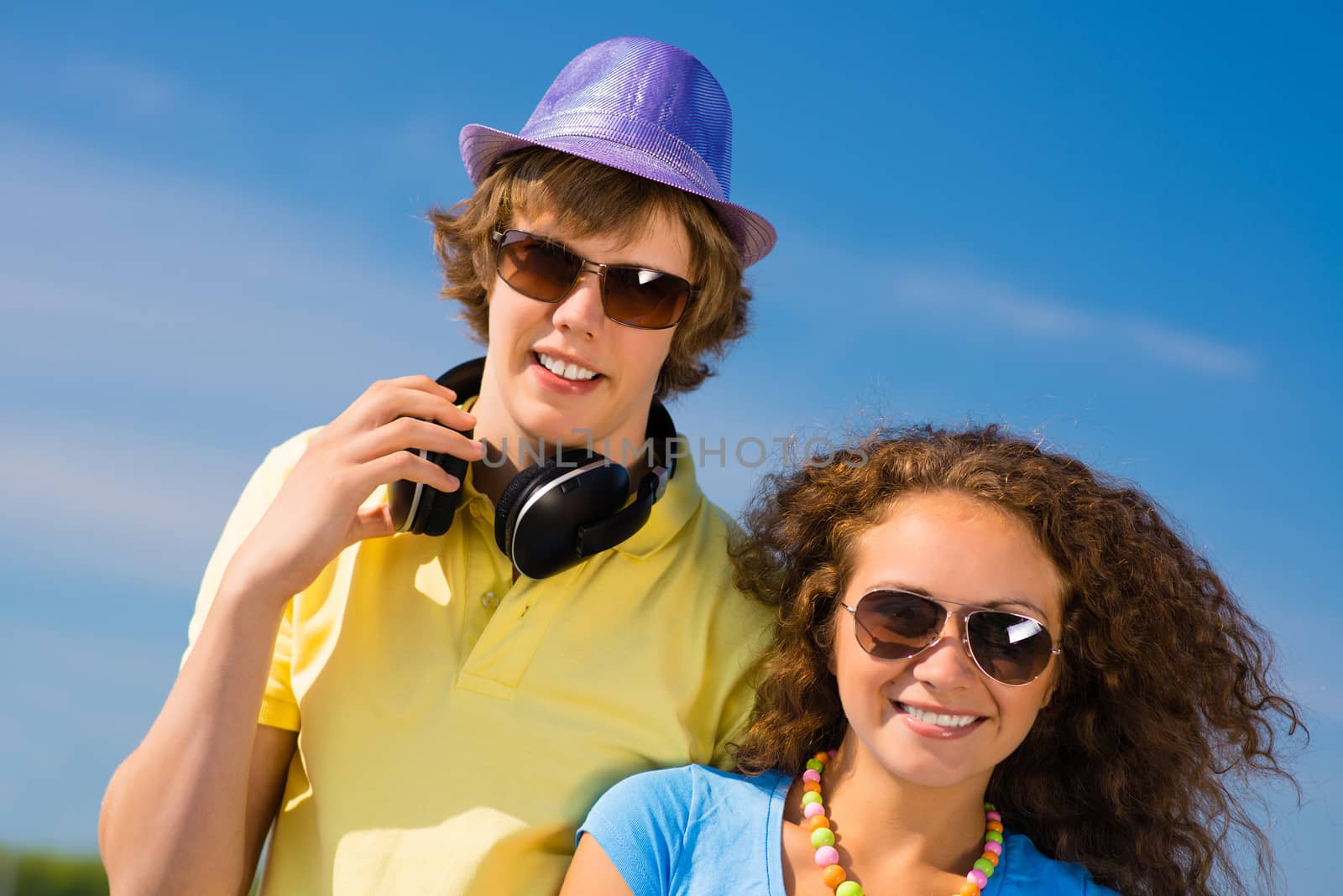 young couple standing on the road, having fun with friends