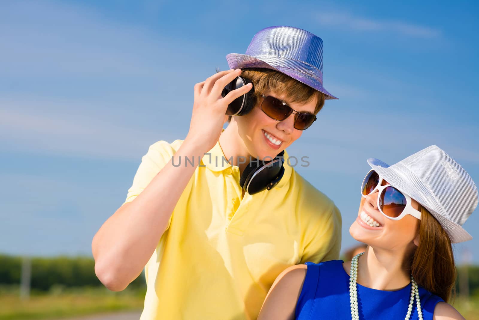 young couple standing on the road, having fun with friends