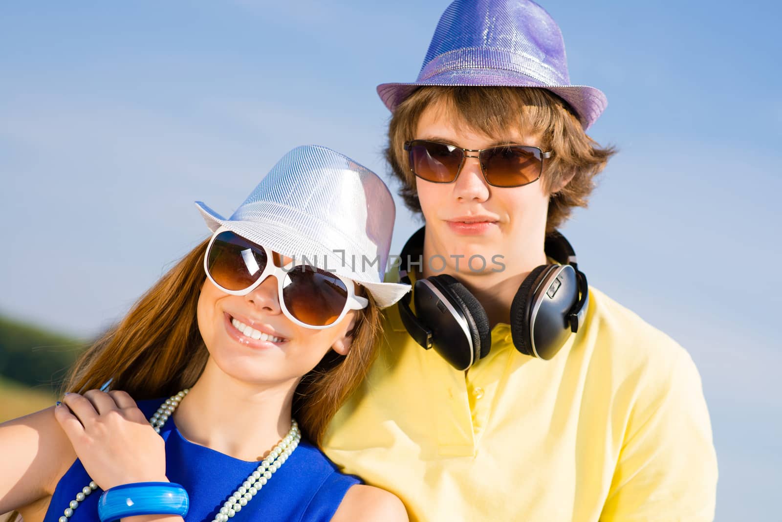 young couple standing on the road, having fun with friends