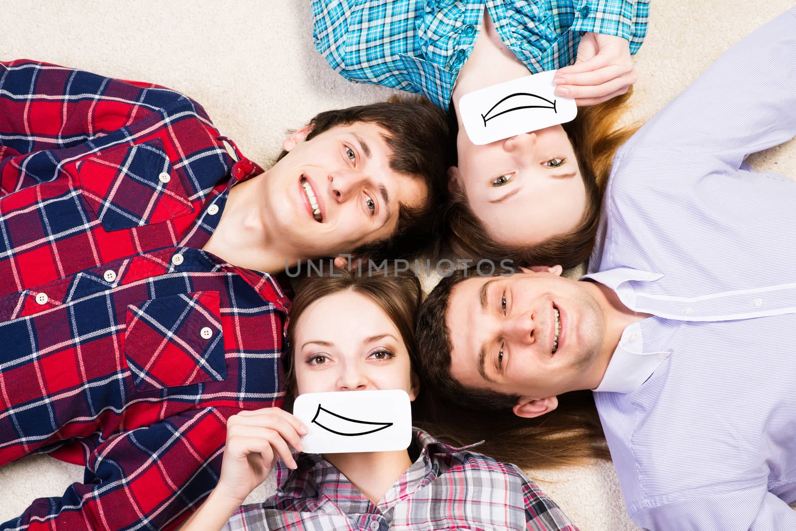 four young men lie together, applied to the face card with smiles